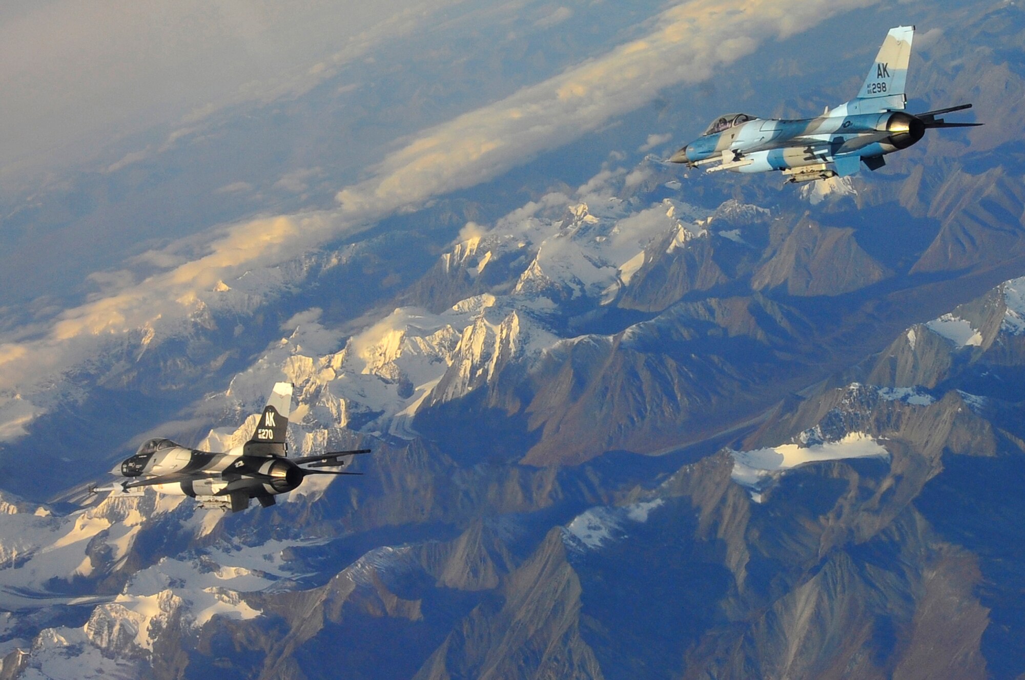 A pair of F-16 Aggressors fly towards 'blue forces' over the Joint Pacific Alaska Range Complex Sept. 14, 2009, Eielson Air Force, Base, Alaska. 'Blue forces' are considered good or friendly forces. The F-16s are assigned to the 18th Aggressor Squadron, which is responsible for training and preparing joint and allied aircrews for combat missions. The JPARC provides 67,000 square miles of airspace, one conventional bombing range and two tactical bombing ranges containing more than 400 different types of targets and more than 30 threat simulators. (U.S. Air Force photo/Staff Sgt. Christopher Boitz)