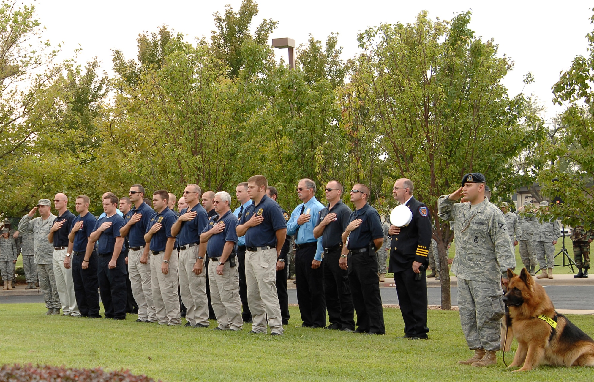 Public safety Airmen and local civilian safety representatives render salutes and salutations during a Patriot Day retreat ceremony, Sept. 11, 2009, at McConnell Air Force Base, Kan.  The 45-minute ceremony was designated to honor those who lost their lives during the Sept. 11, 2001, terrorist attacks. (U.S. Air Force photo/Senior Airman Anthony Mejia)