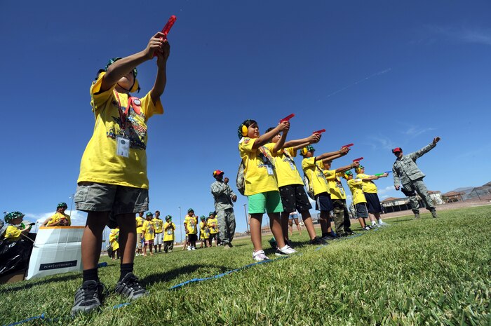 NELLIS AIR FORCE BASE Nev.,-- Eduardo Casiano fires a water pistol at cardboard targets during the weapons training portion of a mock deployment outside the Nellis youth center. The mock deployment is in support of the Kids Understanding of Deployment Operations program better known as Operation KUDO's.  Hundreds of military children participated in the Operation KUDO's deployment at Nellis Air Force Base Sept. 12.
(U.S. Air Force photo by Tech. Sgt. Michael R. Holzworth)
