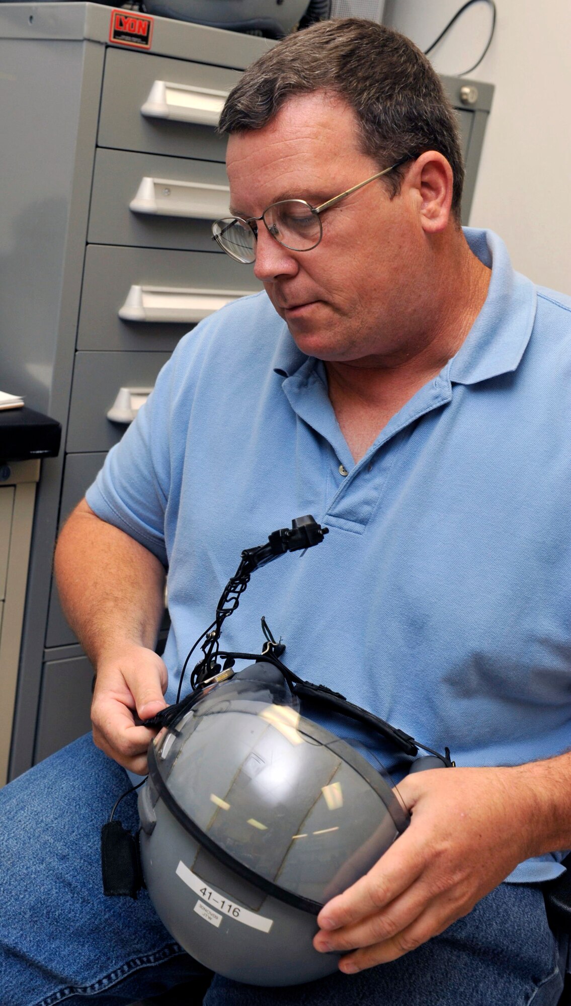 David Reeves, 19th Operations Support Squadron training specialist, inspects an aircrew helmet during a quality assurance check on base Sept. 9. Mr. Reeves won the Outstanding U.S. Air Force Civilian of the Year Award, Category II. (U.S. Air Force photo by Airman Lausanne Pacheco)