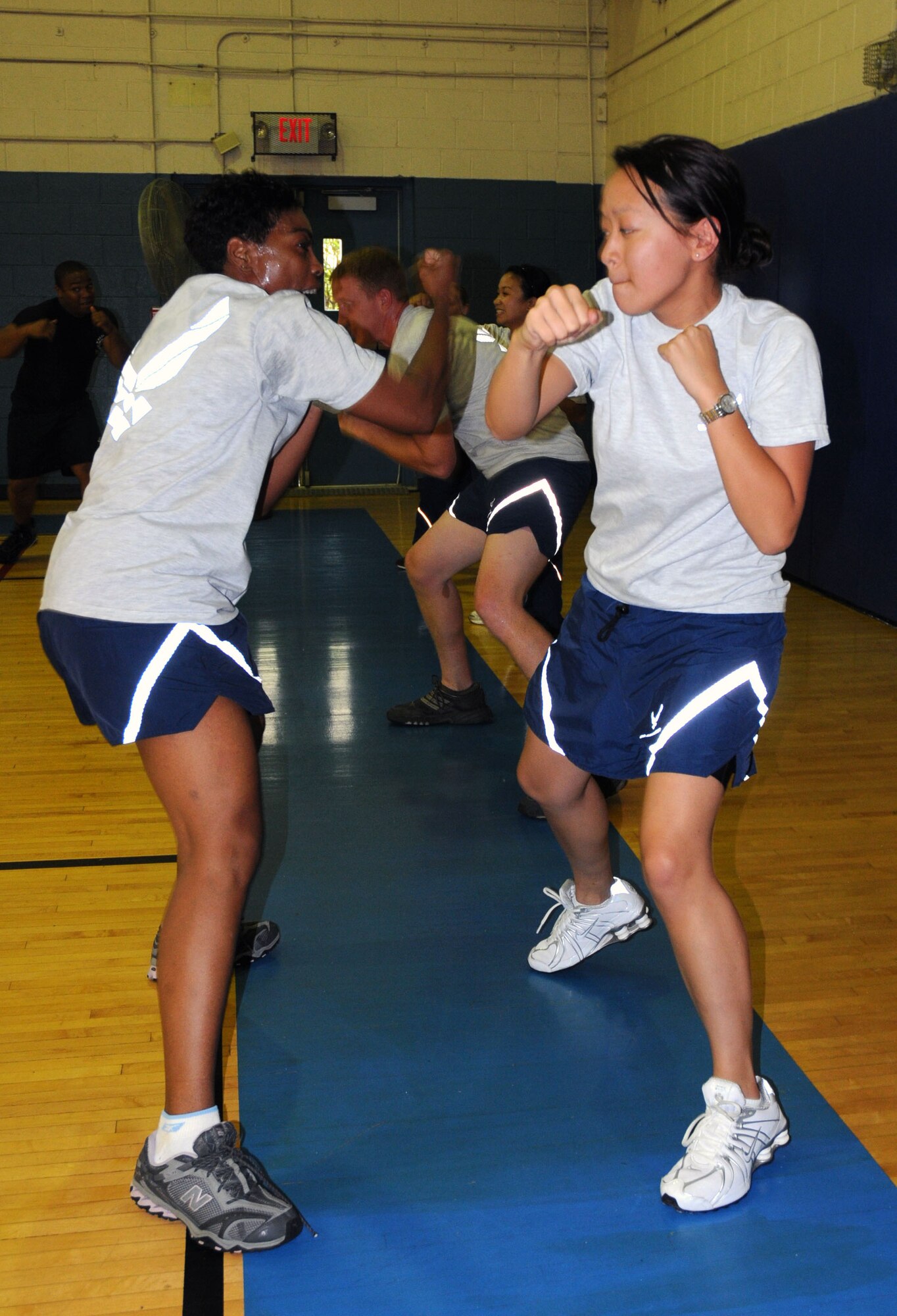 On the left is Tech. Sgt. Gail Reed-Harmon, 512th Memorial Affairs Squadron and a kickboxing instructor, conducts a class at the Dover Air Force Base gym for Liberty Wing Airmen participating in Airmen's Weekend Sept. 12. (U.S. Air Force photo/Master Sgt. Veronica Aceveda)