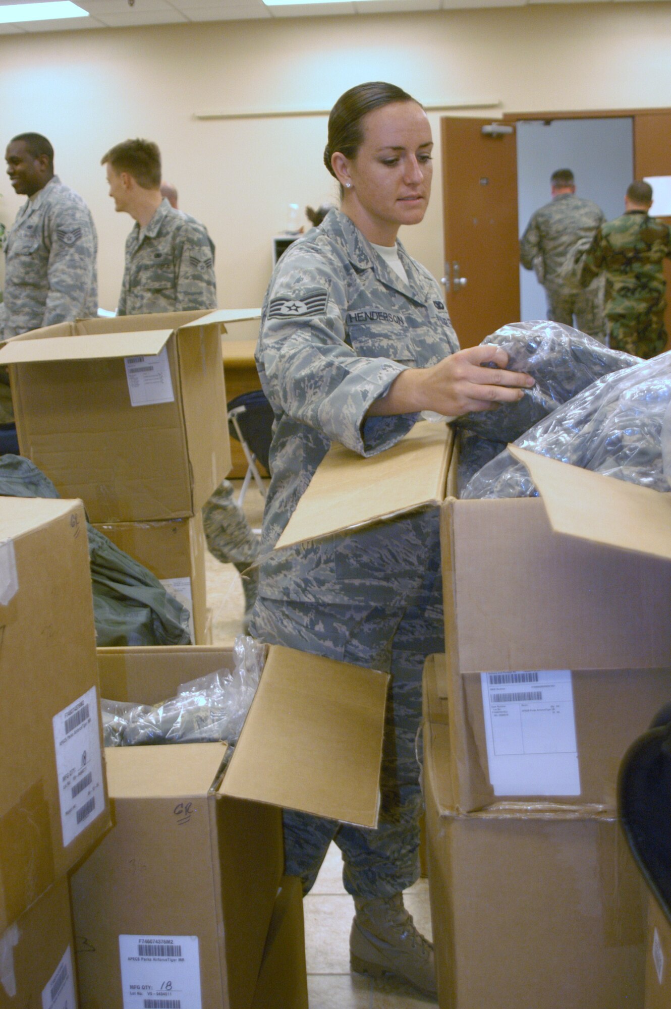 Staff Sgt. Rose Henderson, a 911 dispatcher and fire team member with the 944th Security Forces Squadron, tries on a Gore-Tex Airman Battle Uniform Sept. 13. The 944th Logistics Readiness Squadron was able to buy and outfit the entire wing with jackets and rank. (U.S. Air Force photo/Tech. Sgt. Barbara Plante)