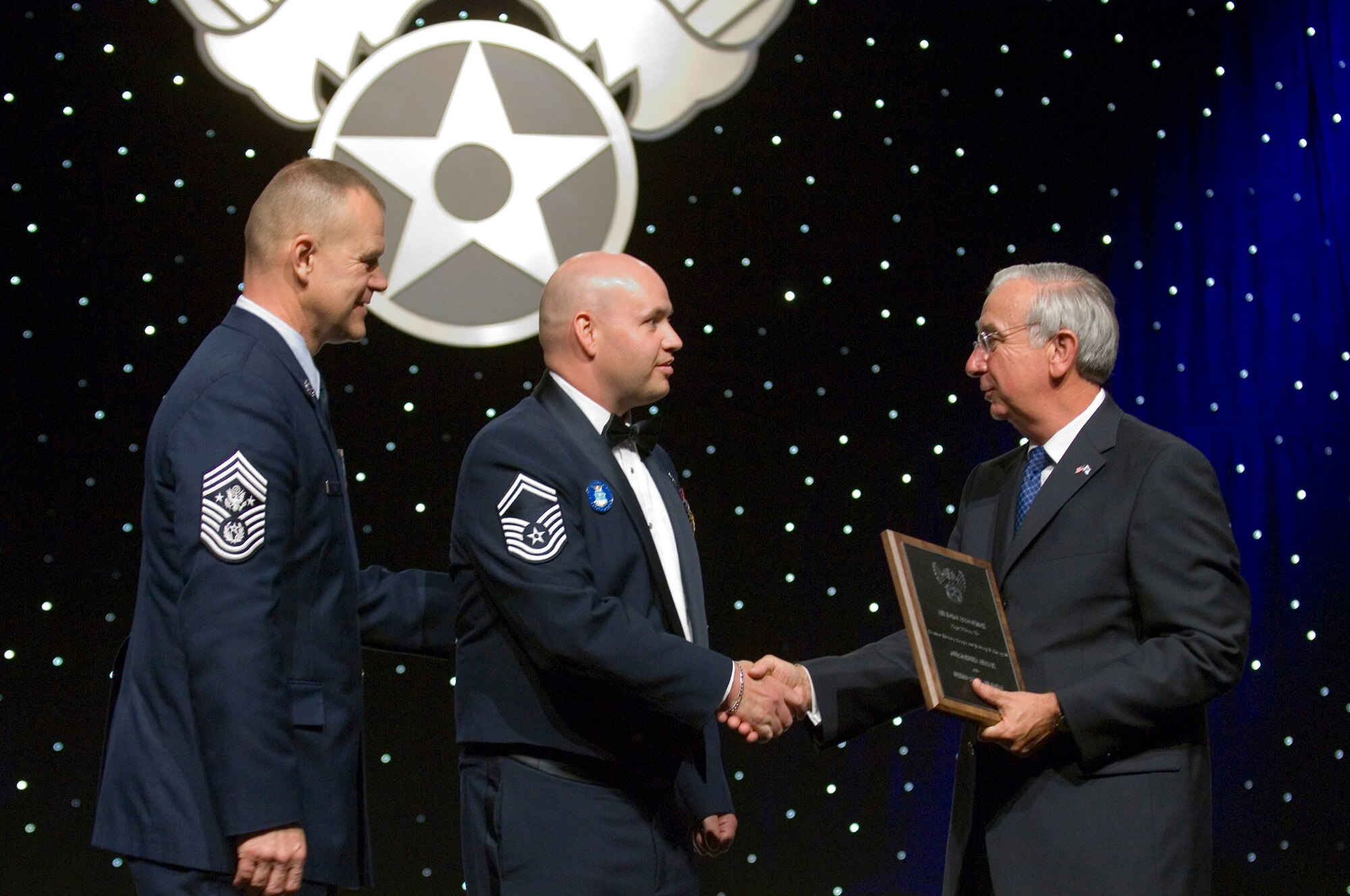 Senior Master Sgt. Jeffery Steagall receives an award Sept. 14, 2009, from Chief Master Sgt. of the Air Force James A. Roy and AFA Chairman of the Board Joseph E. Sutter during the 2009 Outstanding Airmen of the Year dinner at the Gaylord National Hotel and Convention Center, National Harbor, Md. Sergeant Steagall is a communications and information systems inspections manager assigned to Peterson Air Force Base, Colo. Sergeant Steagall is one of the twelve Outstanding Airmen of the Year.(U.S. Air Force photo/Staff Sgt. Desiree N. Palacios)