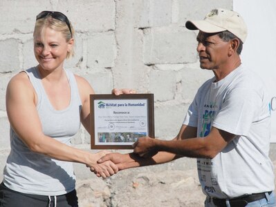 SOTO CANO AIR BASE, Honduras — Army Capt. Diana Parzik, volunteer coordinator for the project, receives a certificate of appreciation from Ramiro Martinez, Habitat for Humanity Honduras coordinator, Sept. 12 in La Paz for all the work she has done helping with Habitat for Humanity. JTF-Bravo members have been working with Habitat since March 28, and since then they have helped Habitat with a total of 11 houses in La Paz and Comayagua (U.S. Air Force photo/Staff Sgt. Chad Thompson).