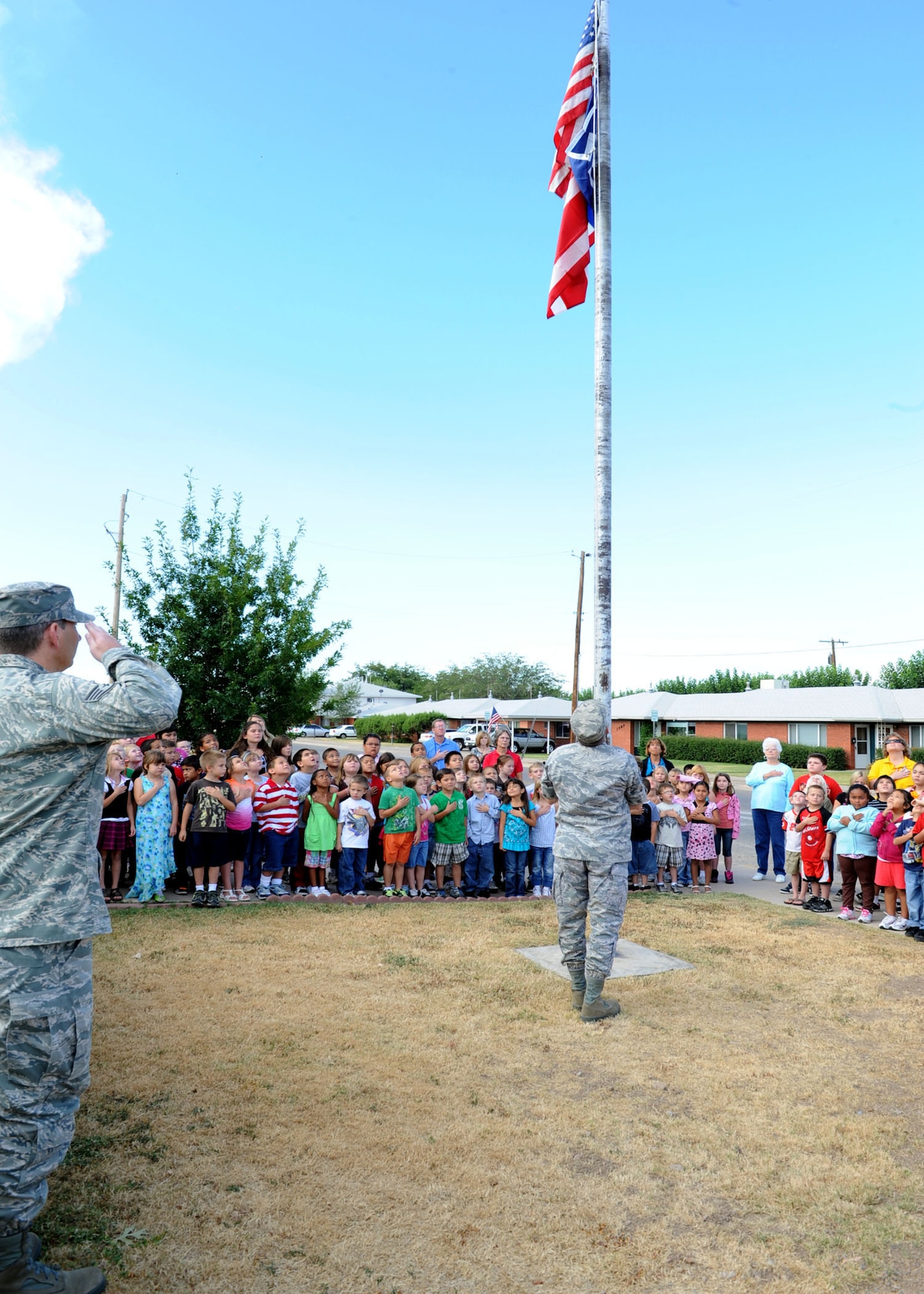 ALAMOGORDO, N.M. -- Master Sgt. Marcus Cooper, 49th Maintenance Squadron at Holloman Air Force Base, raises a Freedom Flag at Oregon Elementary School here. The Freedom Flag was created after Sept. 11 by Richard Melito and donated to all schools in the Alamogordo Public School District by the Holloman Top 3. (U.S. Air Force photo by Senior Airman Rachel Kocin)