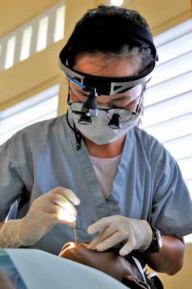 Capt. Dan Nguyen performs a root canal on a Guyanese woman during exercise New Horizons Guyana 2009 July 20, 2009, in Diamond, Guyana. New Horizons Guyana 2009 is a U.S. Southern Command-sponsored humanitarian event that will benefit thousands of Guyanese citizens in Georgetown and outlying areas. Captain Nguyen is assigned to the 59th Dental Group from Lackland Air Force Base, Texas. (U.S. Air Force photo/Airman 1st Class Perry Aston)
