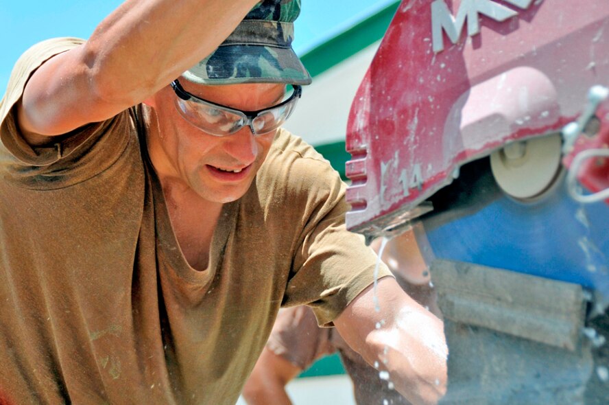 Tech. Sgt. Kevin Dillon cuts a block during a construction project July 7, 2009, in Georgetown, Guyana as part of New Horizons Guyana. The U.S. Southern Command-sponsored humanitarian event is intended to benefit thousands of Guyanese in Georgetown and its outlying areas. Sergeant Dillon is a structures technician with the 910th Civil Engineering Squadron out of Youngstown Air Reserve Station, Ohio. (U.S. Air Force photo/Airman 1st Class Perry Aston) 