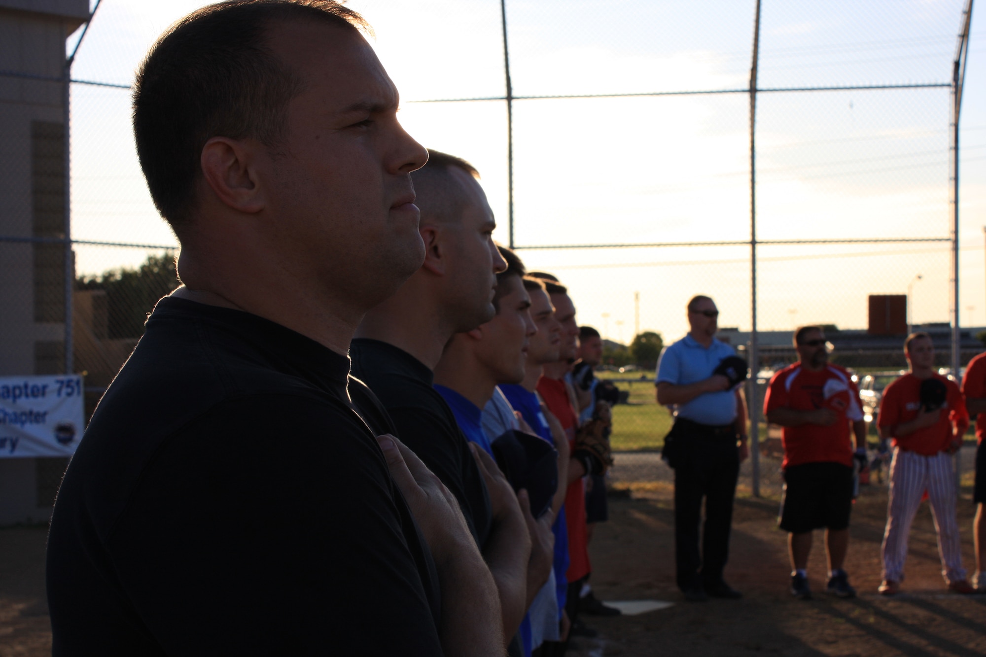WRIGHT-PATTERSON AFB, Ohio - Softball players from the 445th Airlift Wing stand at attention during the national anthem before the start of the second annual Wright-Patterson Air Force Base Active Duty vs. Reserve Softball Challenge Sep. 12, 2009.  (Air Force photo/Tech. Sgt. Jeremy Caskey) 