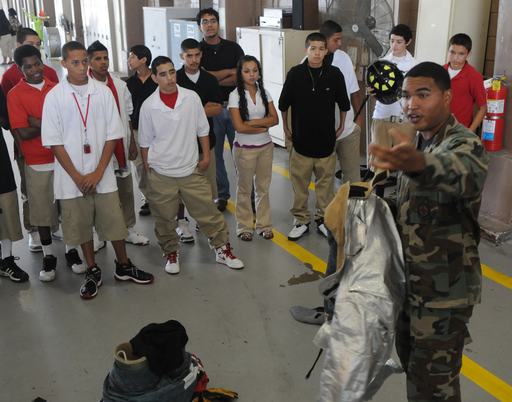 Senior Airman Trevor Alexis, 12th Civil Engineer Squadron Fire Department, briefs members of Giving Americans Motivational Education for the Real World, or GAMER, from Fox Technical High School, on his success since joining the Air Force, as part of their Randolph motivational tour.  (U.S. Air Force photo by Rich McFadden)