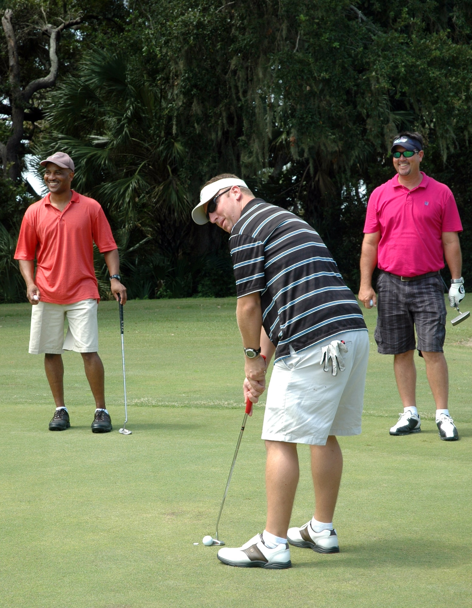 TYNDALL AIR FORCE BASE, Fla -- Col. Timothy Blount, Director of Communications. 1st Air Force, Major Chad Bubanas, 18th Flight Test Squadron, and James Clark enjoy a round a golf during the Military Affairs CommitteeGolf Tournament Sept. 11 at Pelican Point Golf Course, Tyndall Air Force Base. All 18 holes was sponsored by different orginizations around Bay County. (U.S. Air Force photo by Airman 1st Class Rachelle Elsea)