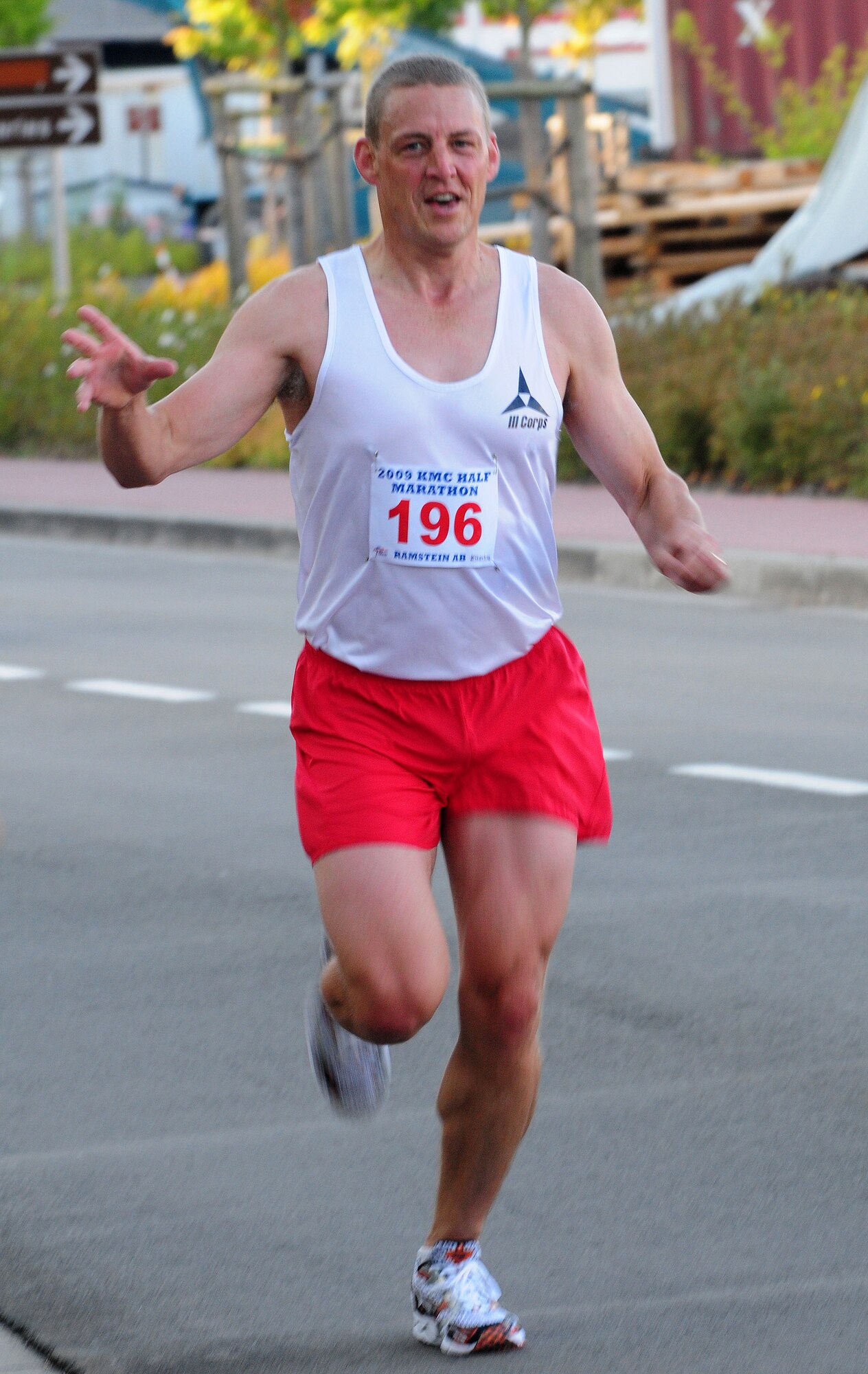 Bill Rediske, Landstuhl Regional Medical Center podiatrist, reaches for water at the six-mile water station as he leads the first ever Kaiserslautern Military Community Half Marathon.  The marathon was held on Ramstein Air Base, Germany, Sept. 12, 2009. (U.S. Air Force photo by Staff Sgt. Jocelyn Rich)