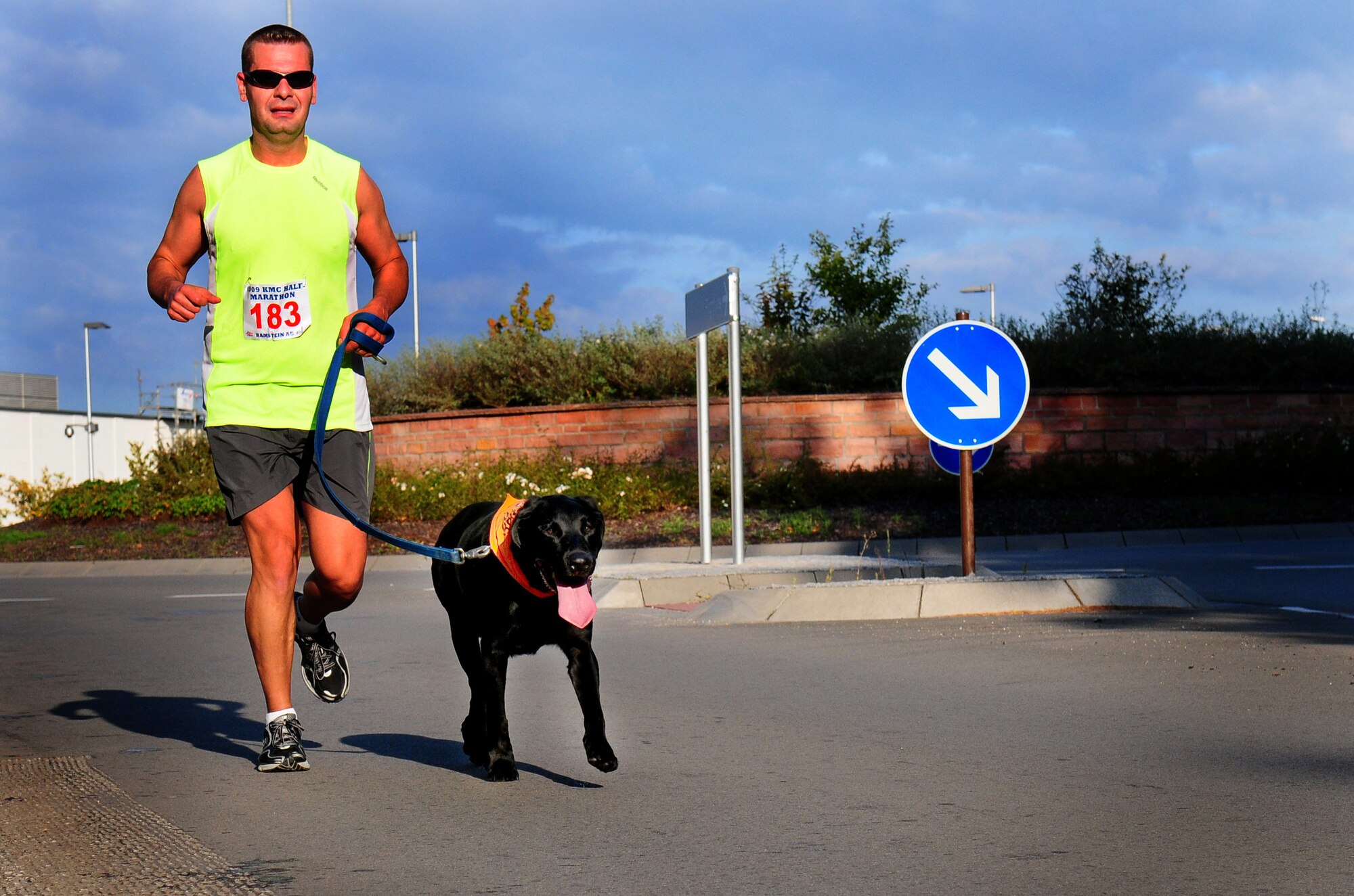 Marty Dufek, 17th Air Force plans and programs, runs with his dog past the six-mile mark of the first ever Kaiserslautern Military Community Half Marathon, Ramstein Air Base, Germany, Sept. 12, 2009.  Dufek, as well as his canine companion, completed the 13.1-mile trek around the base. (U.S. Air Force photo by Staff Sgt. Jocelyn Rich)  