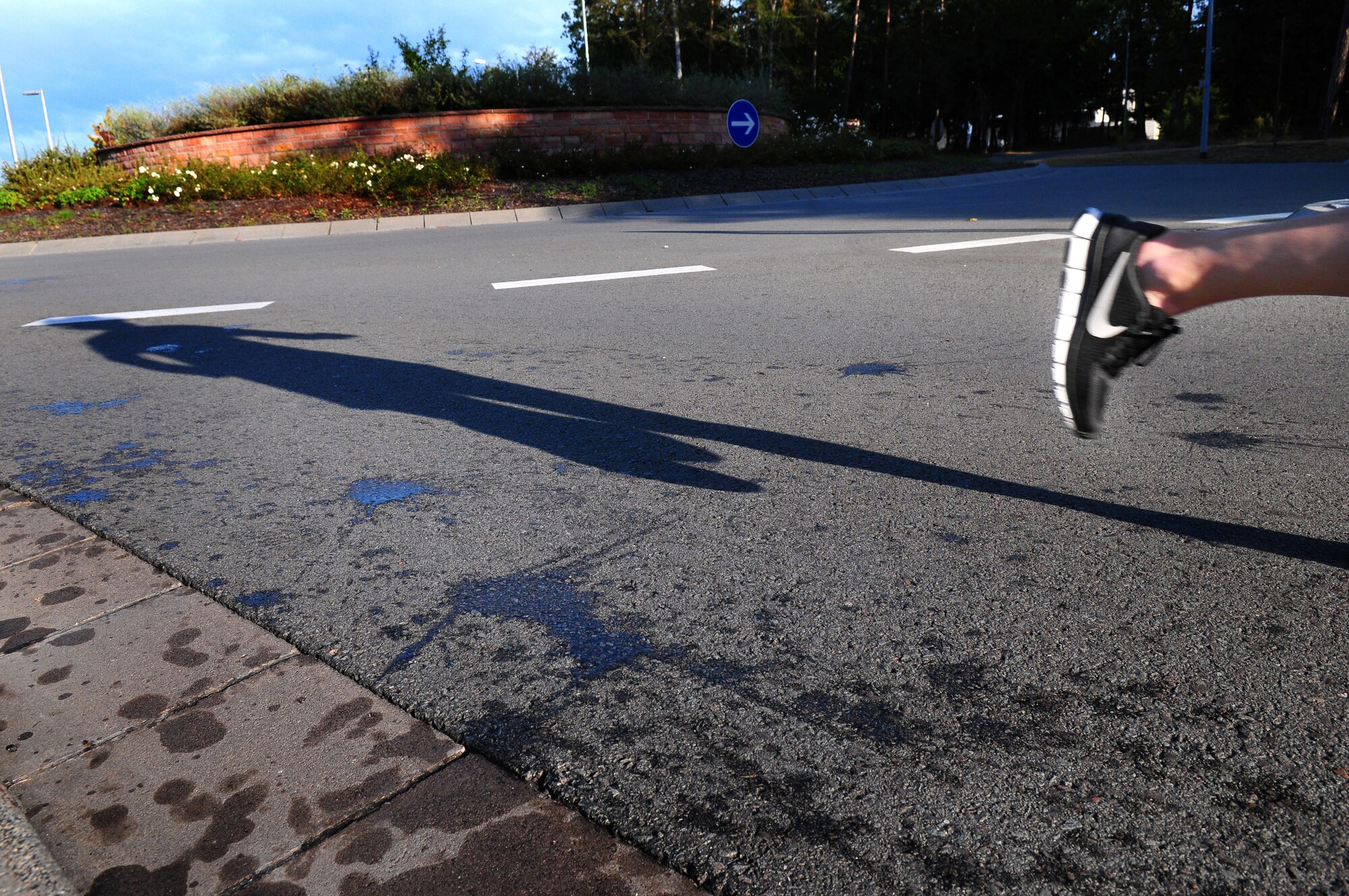 A participant in the first ever Kaiserslautern Military Community Half Marathon passes the six-mile mark, Ramstein Air Base, Germany, Sept .12, 2009.  More than 200 participants ran the 13.1-mile trek around base. (U.S. Air Force photo by Staff Sgt. Jocelyn Rich)