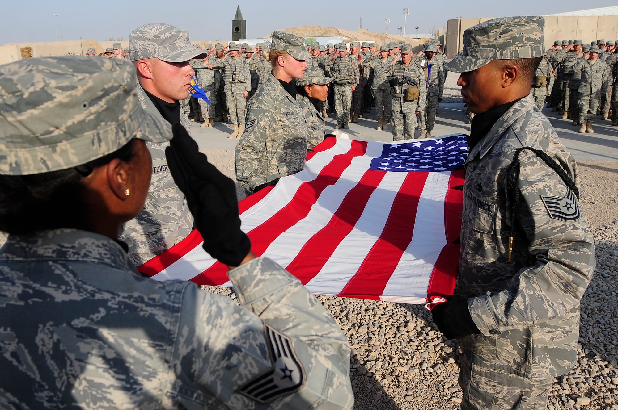 ALI BASE, Iraq – U.S. Air Force members of the honor guard here folds the flag during a retreat ceremony on the eighth anniversary of the terrorist attacks of Sept. 11, 2001. The ceremony was attended by U.S. Airmen, Soldiers, and civilians and paid tribute to those who lost their lives on that fateful day. (U.S. Air Force photo / Senior Airman Tony R. Ritter)