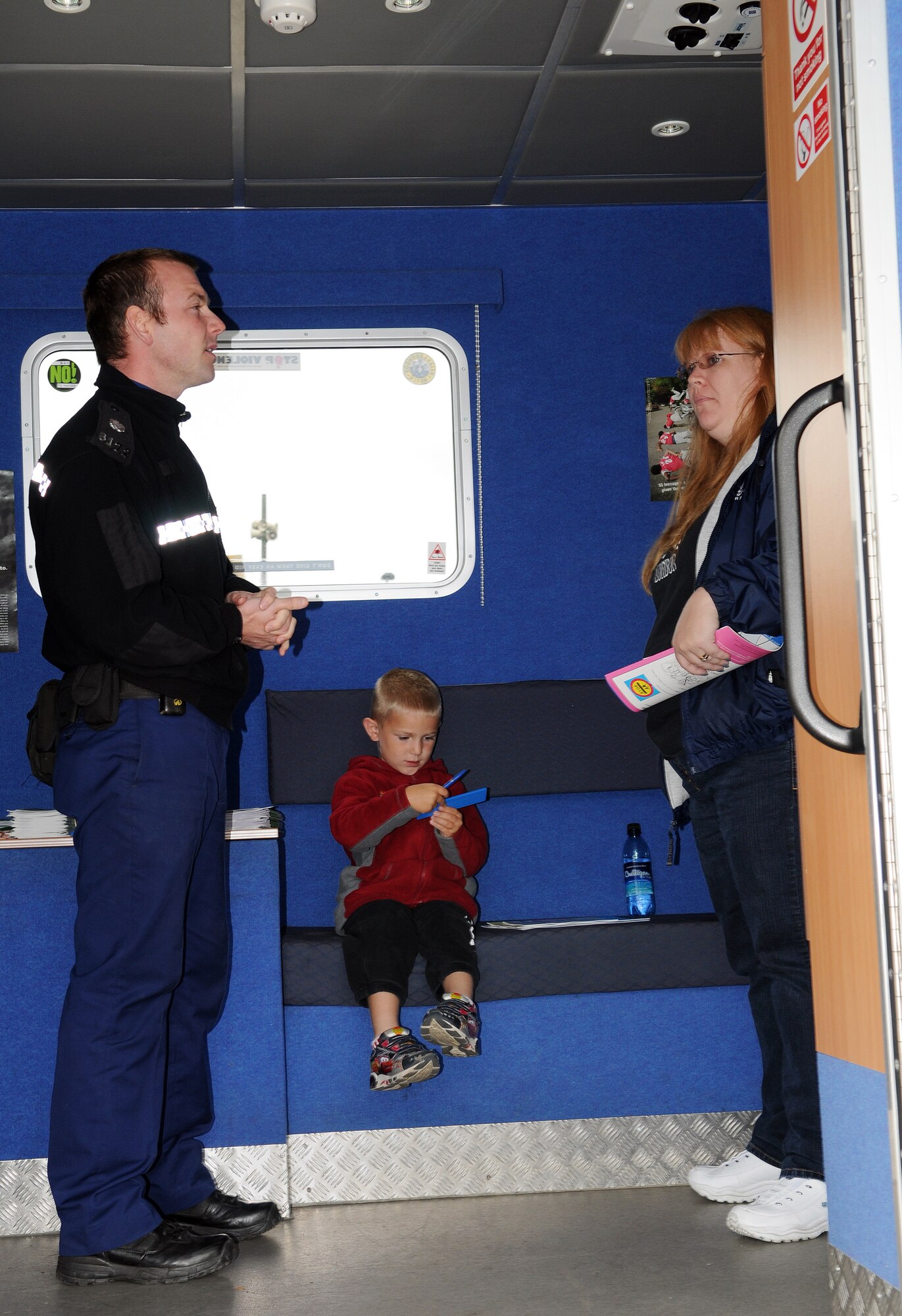 RAF MILDENHALL, England -- Police Community Service Officer Gavin Tampin talks to Mollie Haag and her son Ryan, 5, at a Community Engagement Day Sept. 13. Seven local law enforcement agencies converged at the BXtra here to meet military members and their families who live in the neighborhoods they patrol. The event is scheduled to be held quarterly at RAFs Mildenhall and Lakenheath, said event organizer Ministry of Defence Police Constable Paul Glover, community safety and crime reduction officer. (U.S. Air Force photo/Senior Airman Thomas Trower)