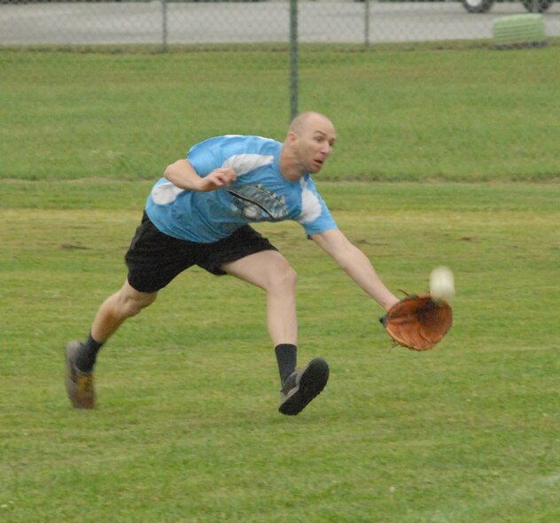 William Cronin, 436th Maintenance Squadron, reaches for a pop fly hit in the fifth inning.  (U.S. Air Force photo/Staff Sgt. Chad Padgett)