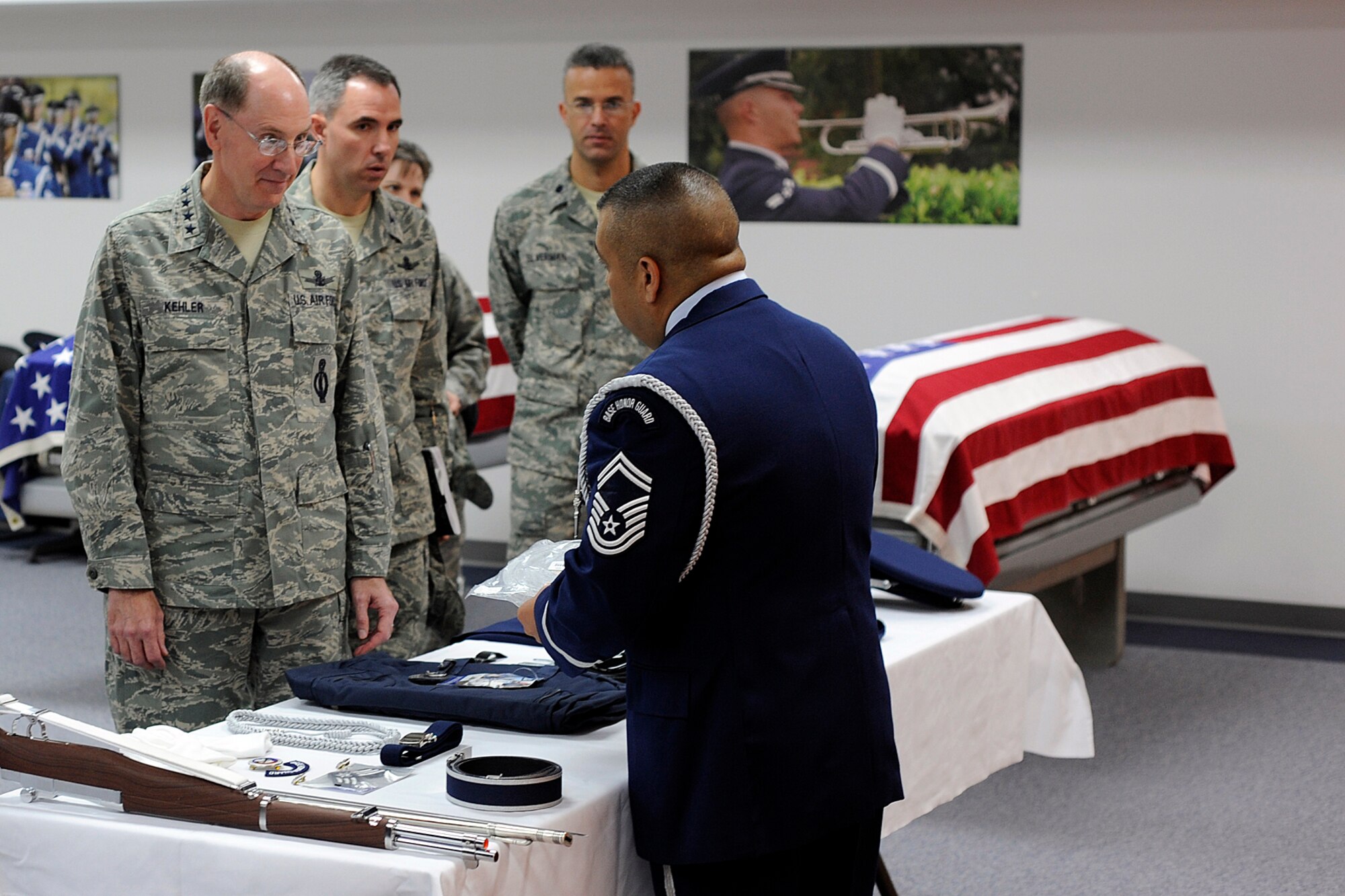 Senior Master Sgt. Timothy Martinez, 21st Space Wing honor guard mission director, briefs Gen. C. Robert Kehler, Air Force Space Command commander, Sept. 9 on uniform and equipment given to new High Frontier Honor Guard members at Peterson. The High Frontier Honor Guard is comprised of 14 Airmen stationed at Peterson, Schriever, and Cheyenne Mountain Air Force Station, who perform at special ceremonies in Colorado and eight western Kansas counties. Their area of responsibility covers 93,000 square miles. General Kehler’s visit included stops at several 21st SW locations, opportunities to speak with Airmen and a 21st SW mission brief. (Air Force photo by Larry Hulst)