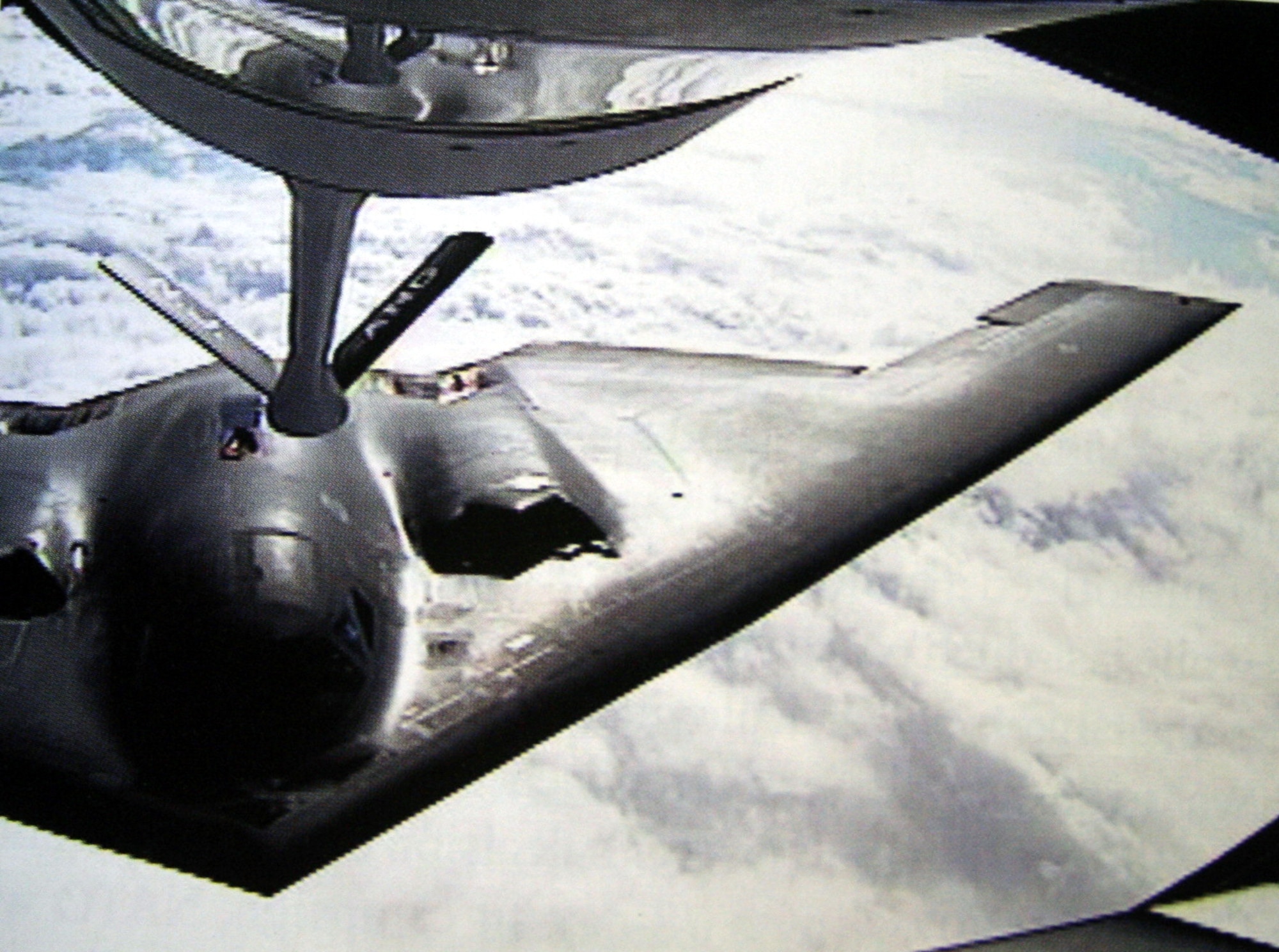 A KC-135R Stratotanker refuels a B-2 Spirit over the Atlantic Ocean during Operation Allied Force in 1999. The first combat missions of the stealth bomber were the product of a team effort with Air Mobility Command's tanker fleet. (U.S. Air Force History Photo)