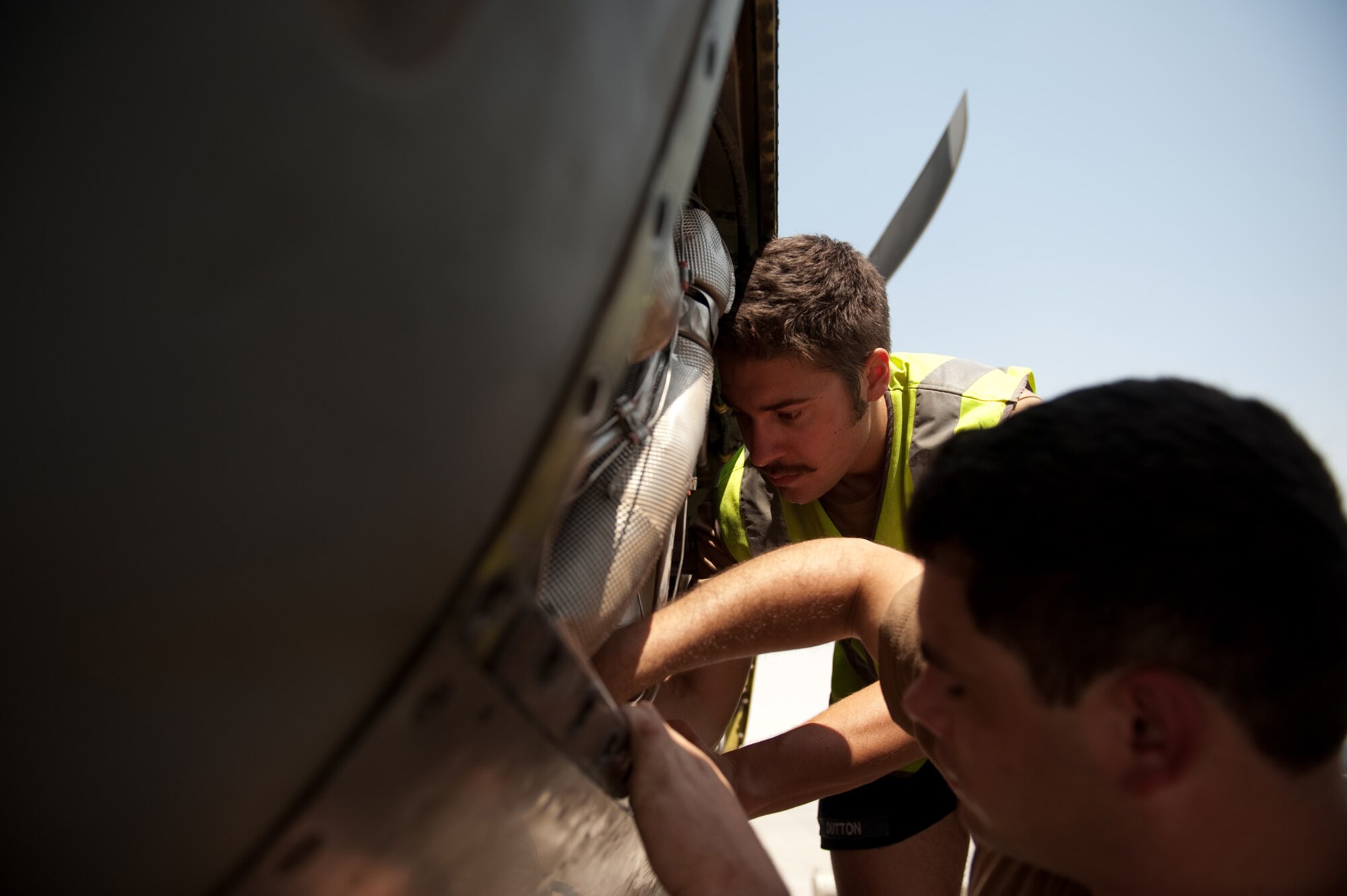 Left, Royal Australian Air Force Leading Aircraftsman Evan Dutton and Corporal Robert Freeman, No 37 Squadron, troubleshoot an engine problem on a C-130J, Sept. 14, in Southwest Asia. The No 37 Squadron flies a variety of missions to provide intra-theater combat airlift support for Australian Defense Forces and coalition partners throughout Southwest Asia. RAAF servicemembers are deployed from RAAF Base Richmond, New South Wales, Australia, in support of Operation Enduring Freedom. (U.S. Air Force photo/Staff Sgt. Robert Barney/RELEASED) 