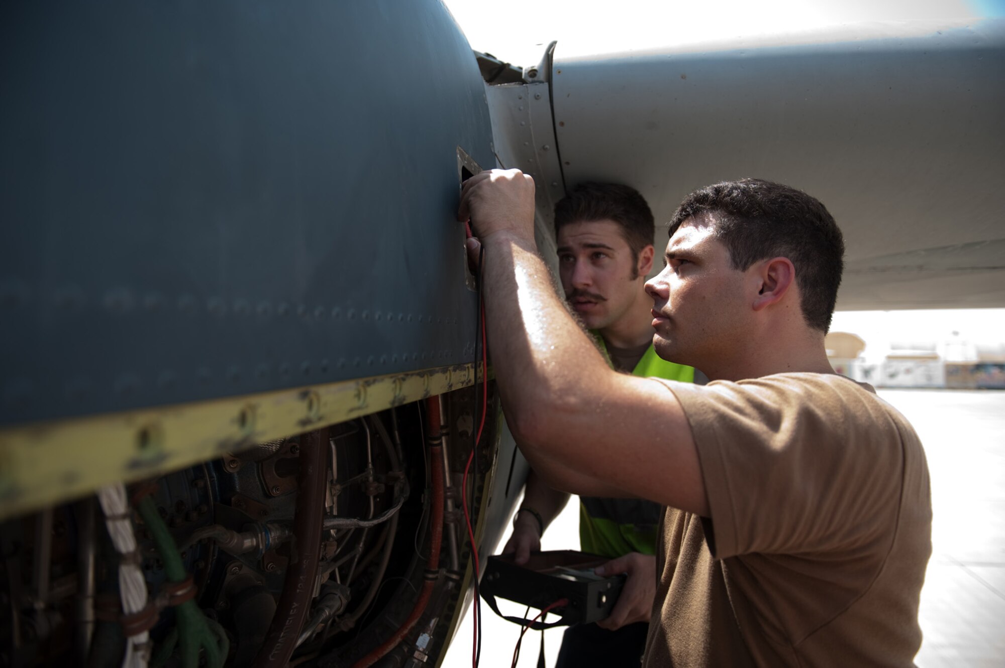 Left, Royal Australian Air Force Leading Aircraftsman Evan Dutton and Corporal Robert Freeman, 37th Squadron, RAAF, troubleshoot an engine problem on a C-130J, Sept. 14, in Southwest Asia. The 37th Squadron flies a variety of missions to provide intra-theater combat airlift support for Australian Defense Forces and coalition partners throughout Southwest Asia. RAAF servicemembers are deployed from RAAF Base Richmond, New South Wales, Australia, in support of Operation Enduring Freedom . (U.S. Air Force photo/Staff Sgt. Robert Barney/RELEASED) 