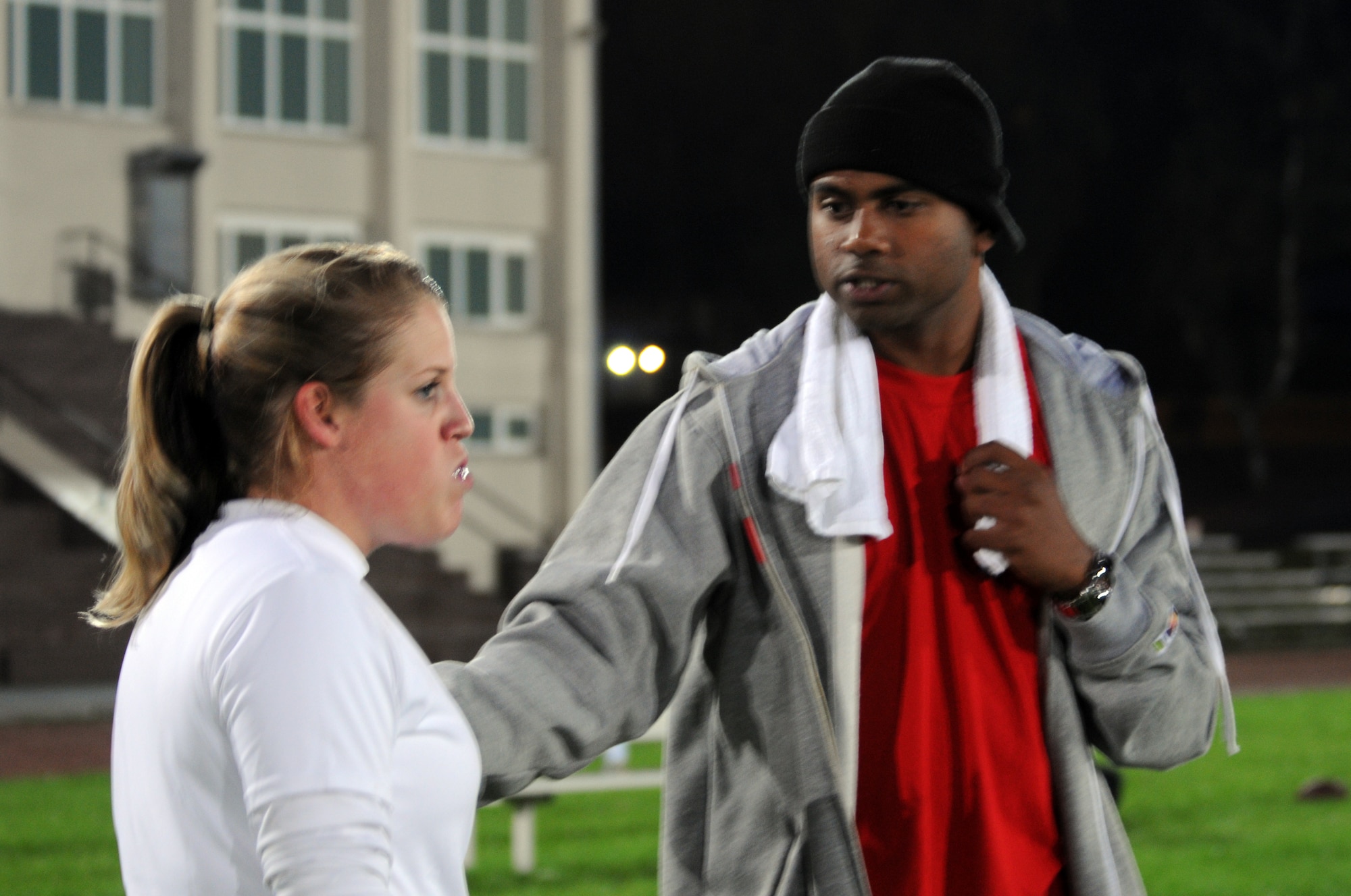U.S. Air Force Senior Airman Lindsay Bly and Staff Sergeant Viji Varkey, both 86th Medical Group technicians, talk about a play during a game Sept. 14, 2009, Vogelweh Military Complex, Germany. Sergeant Varkey is the defensive coach for the team. The 86th MDG beat the 86th Vehicle Readiness Squadron 25-7 in their fourth game of the season. (U.S. Air Force photo by Airman 1st Class Alexandria Mosness)
