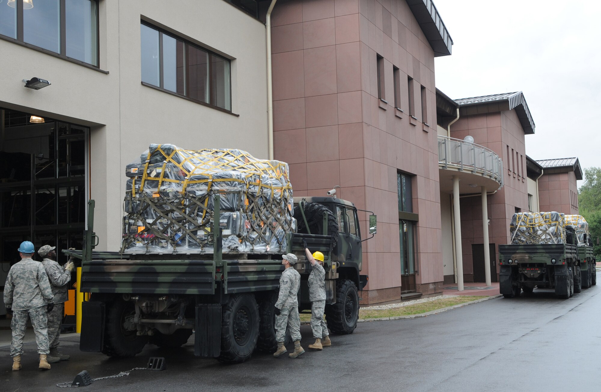 Members of the 1st Combat Communications Squadron secure a pallet in preparation for a convoy exercise from Ramstein Air Base Germany to Aviano Air Base Italy.  The convoy consists of seven trucks carrying approximately 10 tons of cargo.  Once in Italy, members of the 1st Combat Communications Squadron will set up their theater deployable communication package and participate in a 6 day bare base exercise.  (U.S. Air Force photo by: Tech. Sgt. Sean Mateo White)