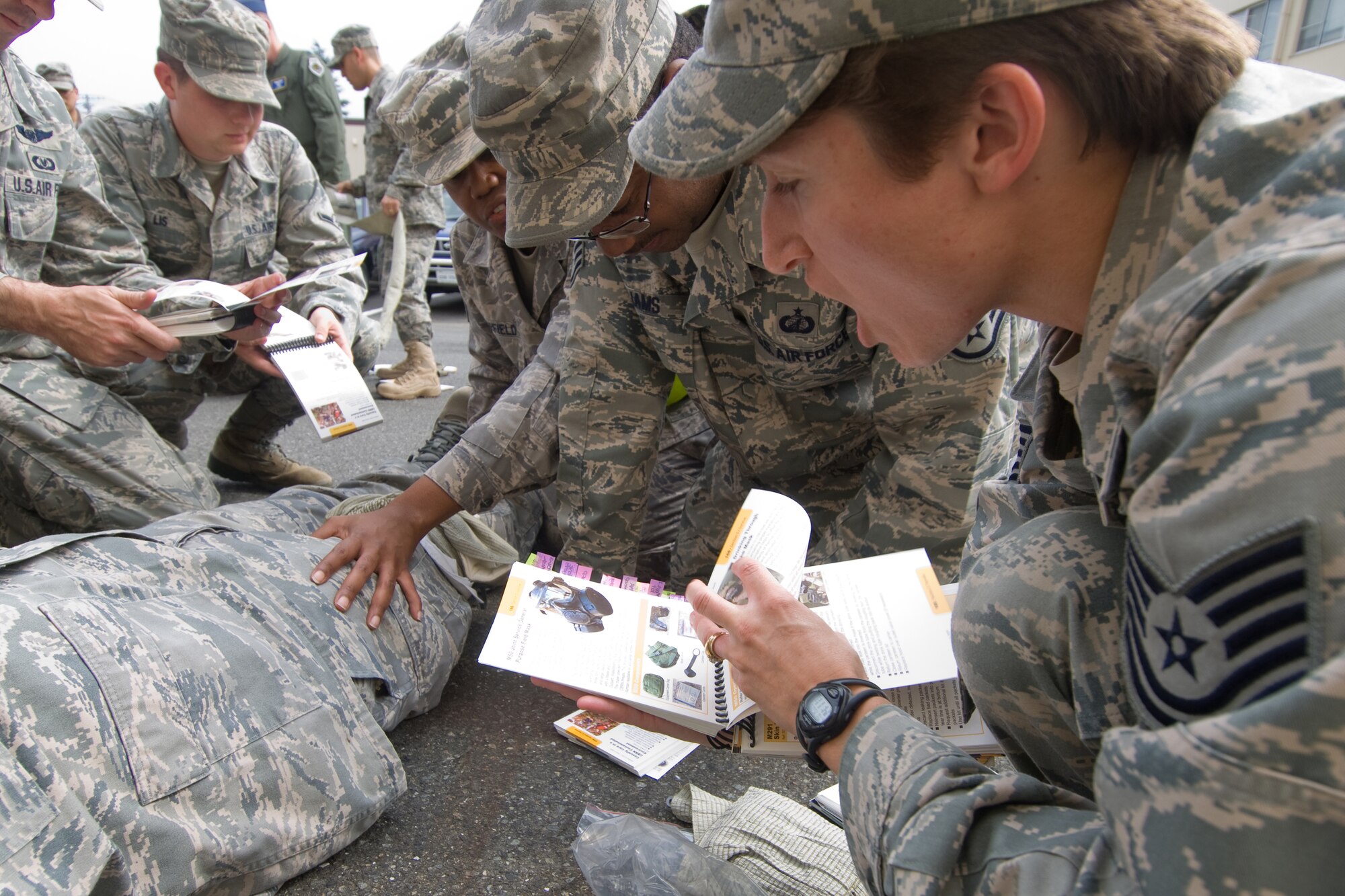 YOKOTA AIR BASE, Japan -- Tech. Sgt. Claire Beck, 374th Comptroller Squadron, (right) helps her fellow 374th Airlift Wing staff agencies Airmen through the proper self-aide, buddy care steps during Ability to Survive and Operate training recently. ATSO knowledge will be an area of emphasis during the wing's upcoming Operational Readiness Inspection. (U.S. Air Force photo/Osakabe Yasuo)
