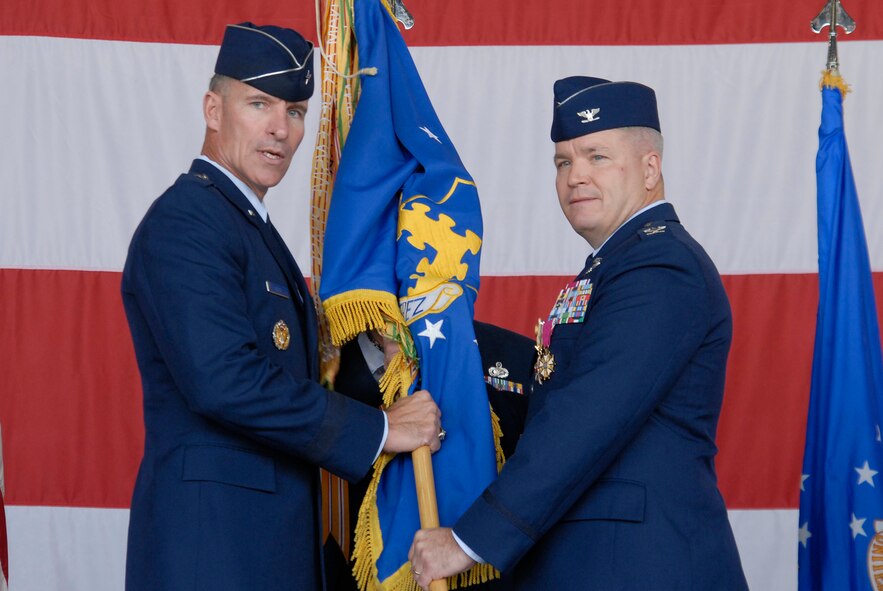 KUNSAN AIR BASE, Republic of Korea -- Brig. Gen. Michael Keltz, 7th Air Force vice commander, hands the guidon to Col. Jerry Harris, commander of the 8th Fighter Wing, before he relinquishes command during the 8th Fighter Wing Change of Command ceremony here Sept. 15. Col. Robert Givens will be the 49th Wolf Pack commander to command the 8th Fighter Wing. Colonel Harris will be the deputy director of Operations, Plans, Requirements and Programs at Headquarters, Pacific Air Forces, Hickam Air Force Base, Hawaii. (U.S. Air Force photo/Staff Sgt. Darnell T. Cannady)