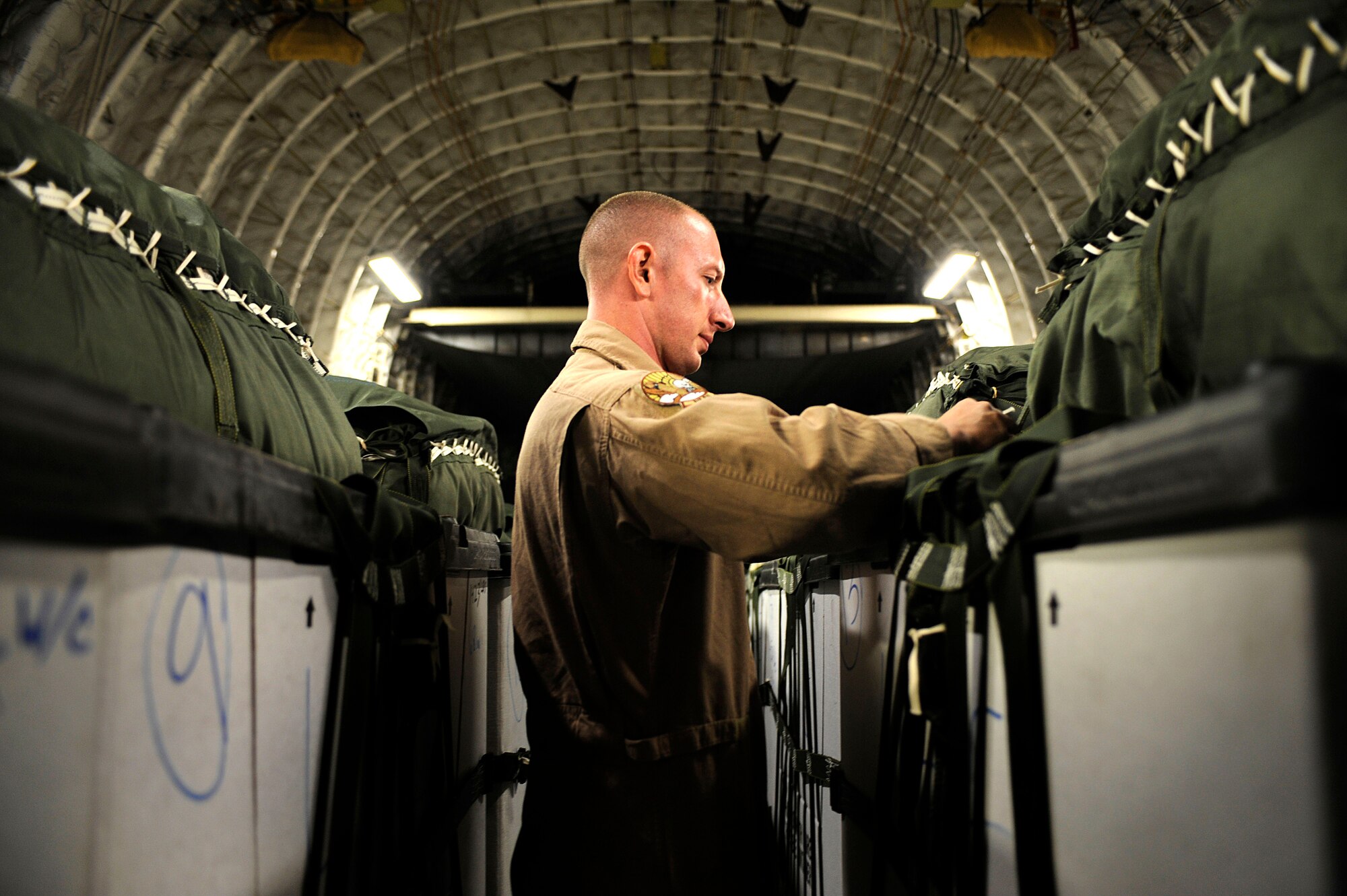 SOUTHWEST ASIA -- U.S. Air Force Staff Sgt. Sam Stewart, a loadmaster assigned to the 816th Airlift Squadron, checks the rigging of a pallet loaded into the cargo bay of a C-17 Globemaster III Sept. 2, 2009, Bagram Airfield, Afghanistan. The pallets will be air-dropped over the southern region of Afghanistan to provide supplies to ground personnel. (U.S. Air Force photo/Staff Sgt. Shawn Weismiller)