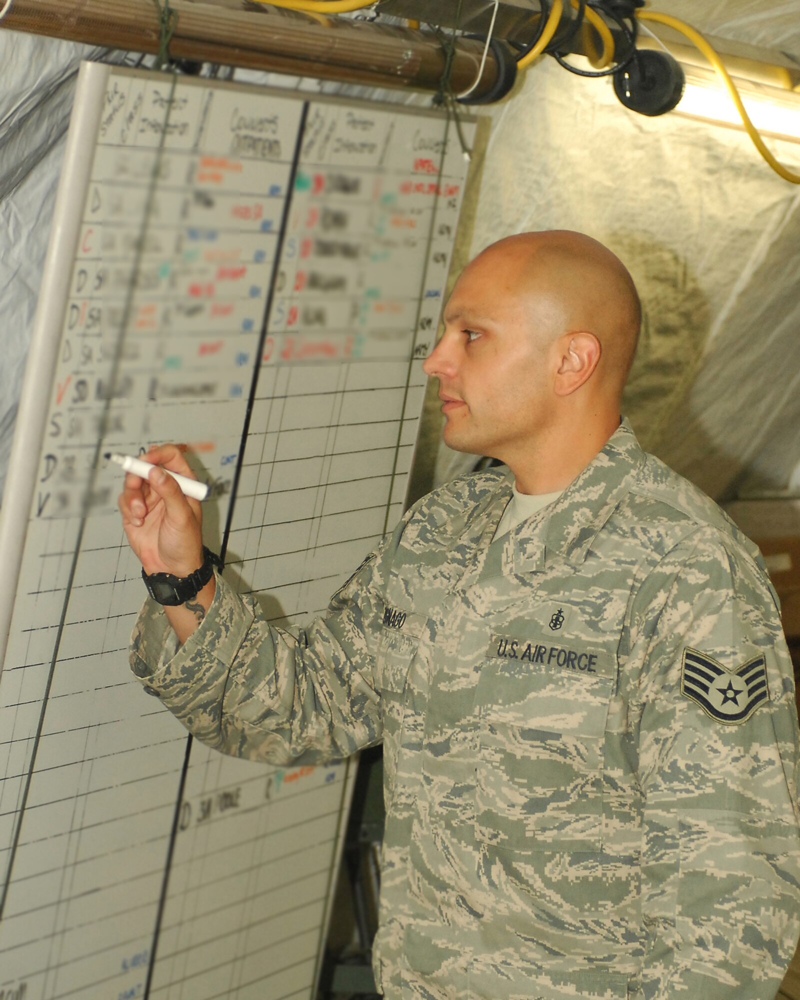 BAGRAM AIRFIELD, Afghanistan – Staff Sgt. Giacomo Zignago, an aerospace medical technician from Task Force Med/455th Expeditionary Medical Group, tracks inbound and outbound patients on a white board at the contingency aeromedical staging facility here, Sept. 13, 2009.  Sergeant Zignago is a Stockton, Calif., native and is deployed from Travis Air Force Base, Calif.  Tracking the patients can be a dynamic and fluid process according to officials here, especially when environmental factors such as weather, noise and the stress of combat are factored in.  The CASF, as it’s known here, is designed to ease the patient-load at the main hospital here and provides and overflow capability.  (U.S. Air Force photo/Senior Airman Felicia Juenke)