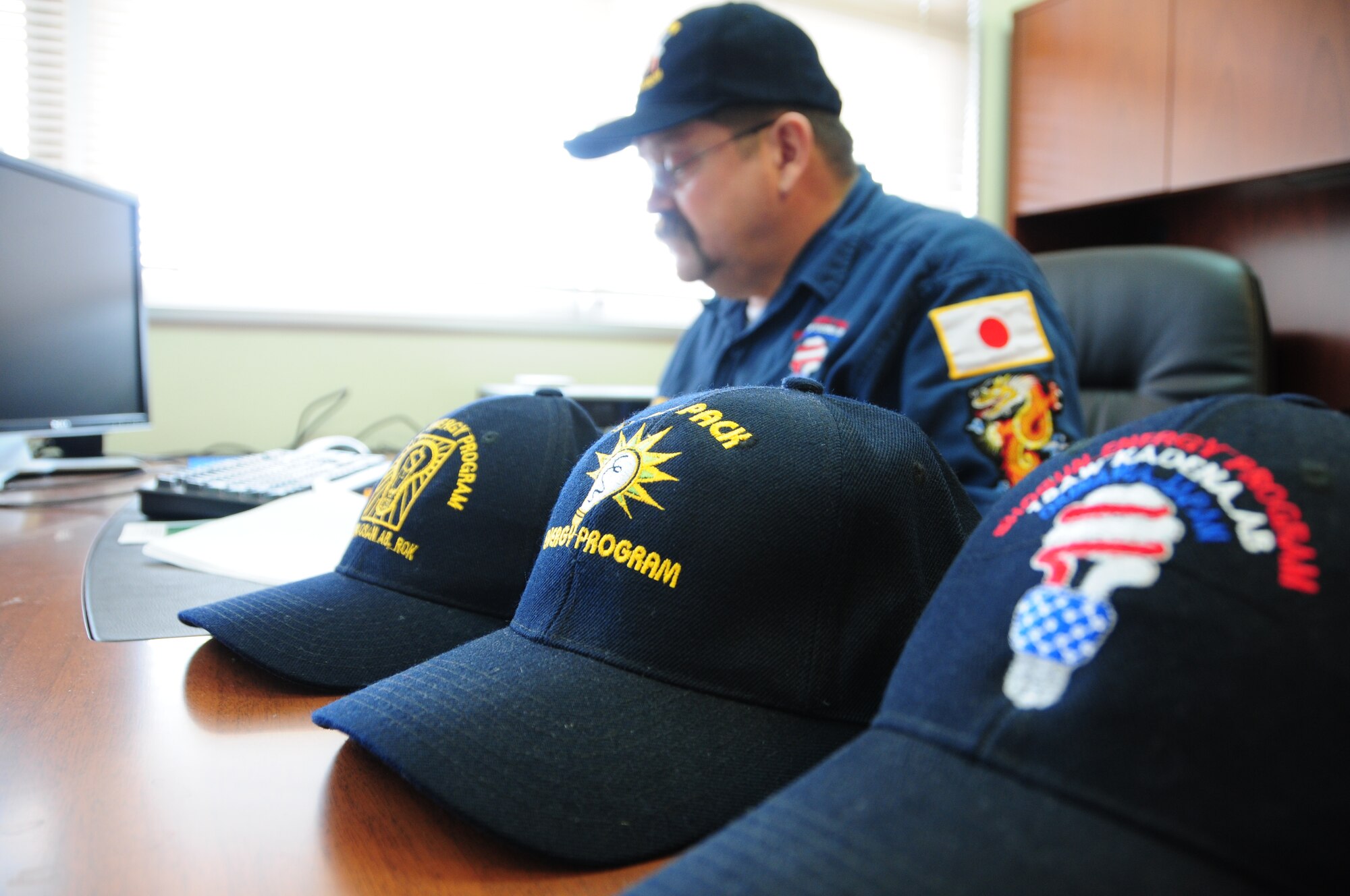 John Muckey, resource efficiency manager for the 718th Civil Engineer Squadron looks over analytical charts on energy conservation, here at Kadena Air Base, Japan. Mr. Muckey was part of a team effort to bring home the 2009 Federal Energy and Water Management Award.  (U.S. Air Force photo/Staff Sgt. Lakisha A. Croley)