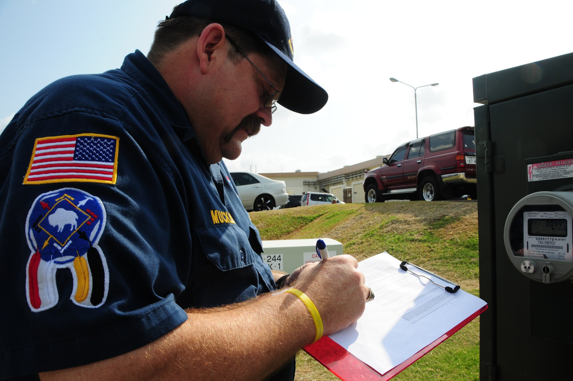 John Muckey, resource efficiency manager for the 718th Civil Engineer Squadron takes a reading from one of the several meters, here at Kadena Air Base, Japan. Mr. Muckey was part of a team effort to bring home the 2009 Federal Energy and Water Management Award.   (U.S. Air Force photo/Staff Sgt. Lakisha A. Croley)