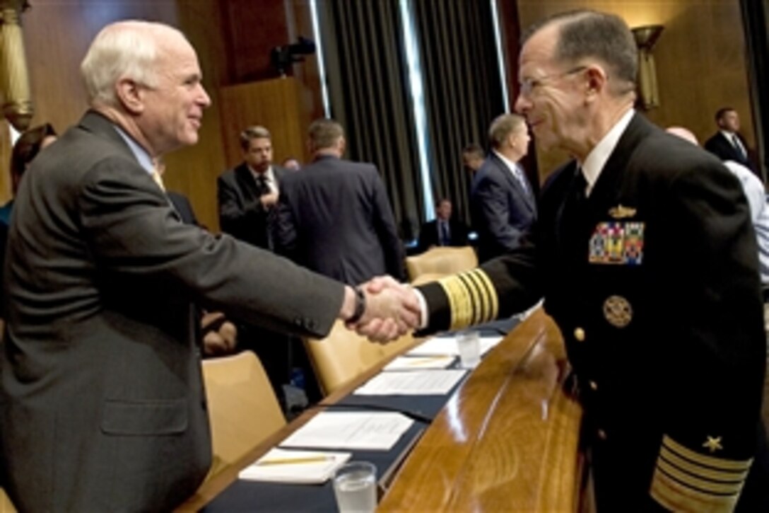 U.S. Navy Adm. Mike Mullen greets U.S. Sen. John McCain before his reconfirmation hearing for a second term as chairman of the Joint Chiefs of Staff at the Dirksen Senate Office Building in Washington, D.C., Sept. 15, 2009.