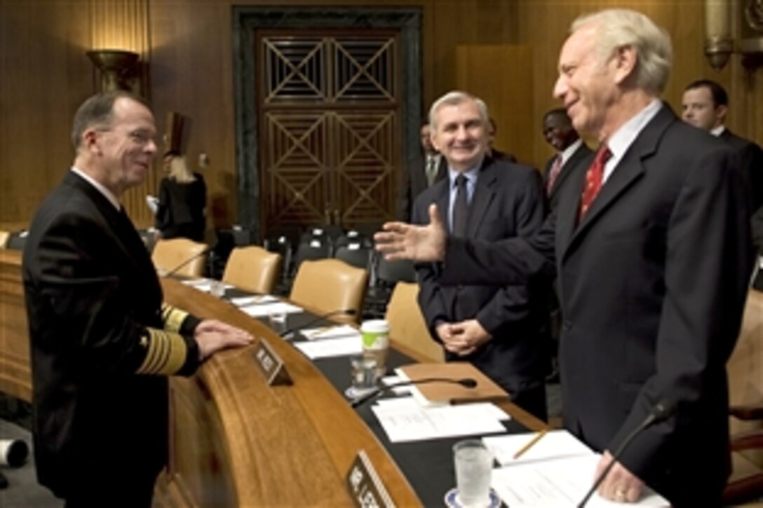 U.S. Navy Adm. Mike Mullen greets Sens. Jack Reed and Joe Lieberman before his reconfirmation hearing for a second term as chairman of the Joint Chiefs of Staff at the Dirksen Senate Office Building in Washington, D.C., Sept. 15, 2009.