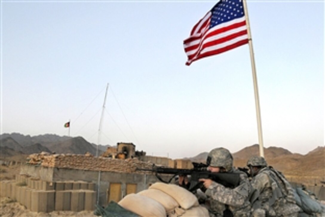 U.S. Army soldiers take their firing positions on a roof top after a mortar landed on Forward Operating Base Baylough in Zabul province, Afghanistan, Sept. 10, 2009. The soldiers are assigned to the Company A, 1st Battalion, 4th Infantry Regiment.