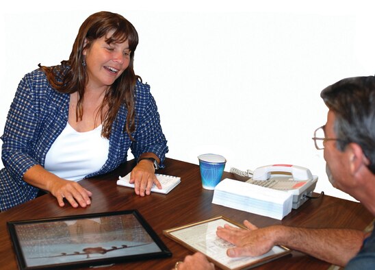 Michael English, a lead loadmaster at the Boeing C-17 ATS Training Facility, shows author Lynne Cox framed mementos from the first mid-winter air mobility drop over Antarctica in 1981. English was a loadmaster for the historic flight. Cox visited March ARB on September 3 to learn more about the Air Force’s Antarctic missions. (U.S. Air Force photo by Megan Just)