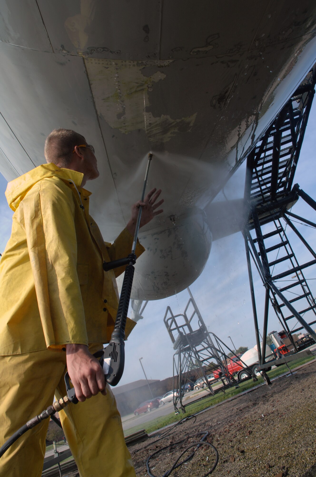 WHITEMAN AIR FORCE BASE, Mo. – Airman Steven Jaeger 509th Maintenance Squadron, uses a power washer to remove the old protective coating and paint on the a KC-97 static display Sept. 16. Once removed members from the 509th Maintenance and Munitions squadrons will restore the protective coating, paint and perform any required sheet metal repair to the KC-97 static display. The restoration, which is required ever 5 years, is scheduled to take one month.  (U.S. Air Force photo/Senior Airman Jessica Snow)