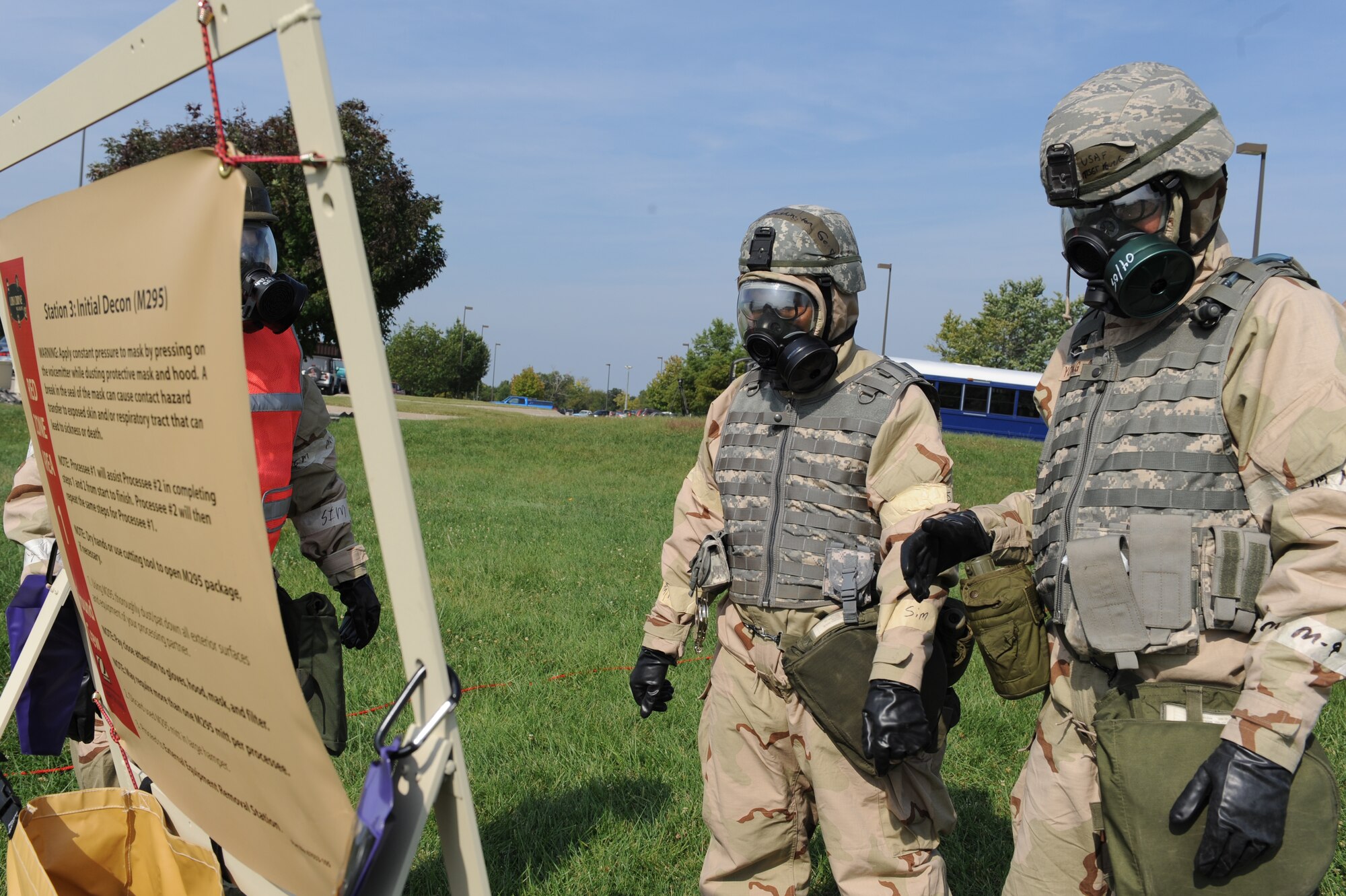 WHITEMAN AIR FORCE BASE, Mo. – Members of the 442nd Fighter Wing read the instructions for decontaminating each other while processing through a chemical line during an exercise, Sept. 16. The 442nd Fighter Wing has exercise to ensure their members remain current on their readiness training. (U.S. Air Force Photo/ SrA Cory Todd)