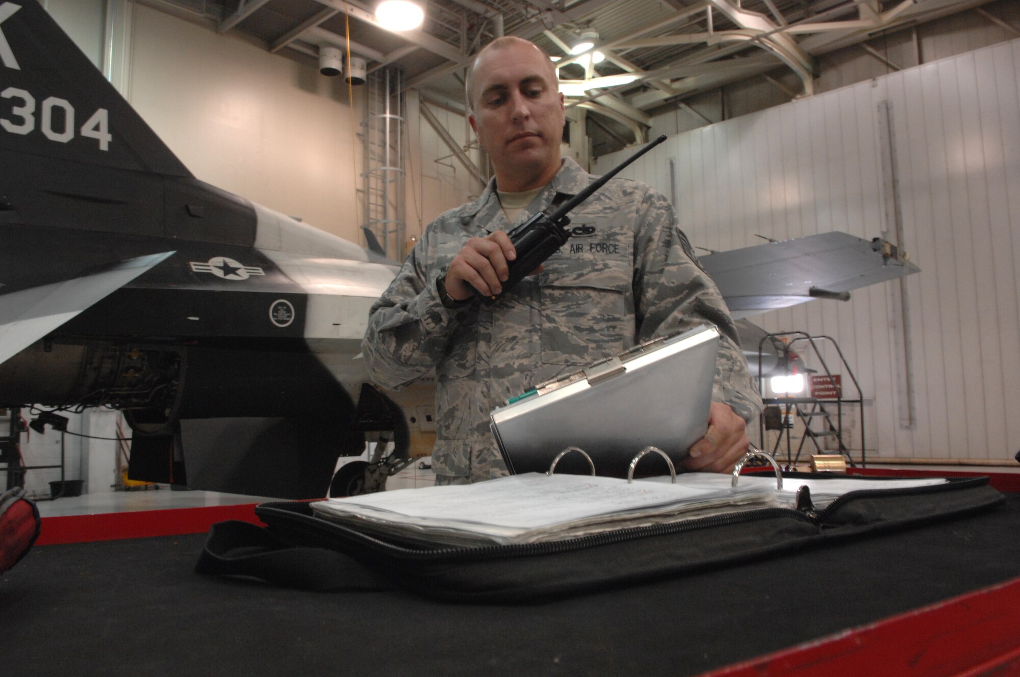 Tech. Sgt. Gary Pursley radios updates for an aircrafts' maintenance status to 354th Maintenance Group Maintenance Operations Center. The MOC staff monitors maintenance status to minamize affects to the mission here. Sergeant Pursley is assigned the the 18th Aggressor Squadron aircraft maintenance unit. (U.S. Air Force photo/Airman 1st Class Rachelle Coleman)