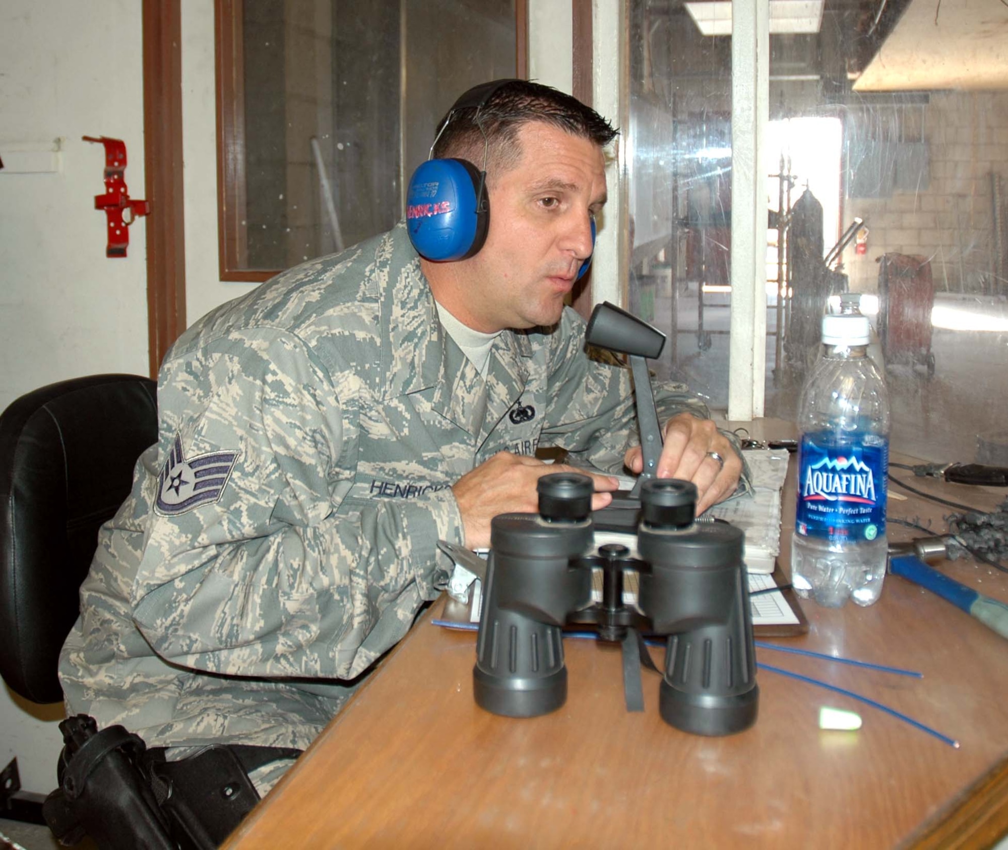 Staff Sgt. Ryan Henricks, 944th Security Forces Squadron, gives instructions as the "tower operator" to other security forces personnel Sept. 12 as they qualify on the M-9. The 944th SFS commander, Maj. Kip Schlum, was one of the participants at Combat Arms Training. (U.S. Air Force photo/Staff Sgt Louis Vega)