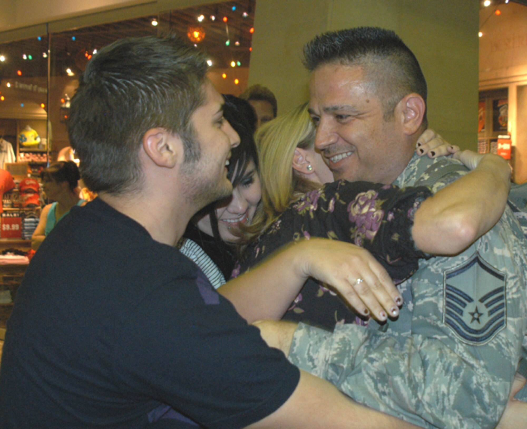 Master Sgt. Roger Barrientos, 944th Fighter Wing information management technician, recieves an emotional welcome home Sept. 15 from his family upon his return from a 60-day deployment to Iraq. (U.S. Air Force photo/Staff Sgt. Stephen Razo) 