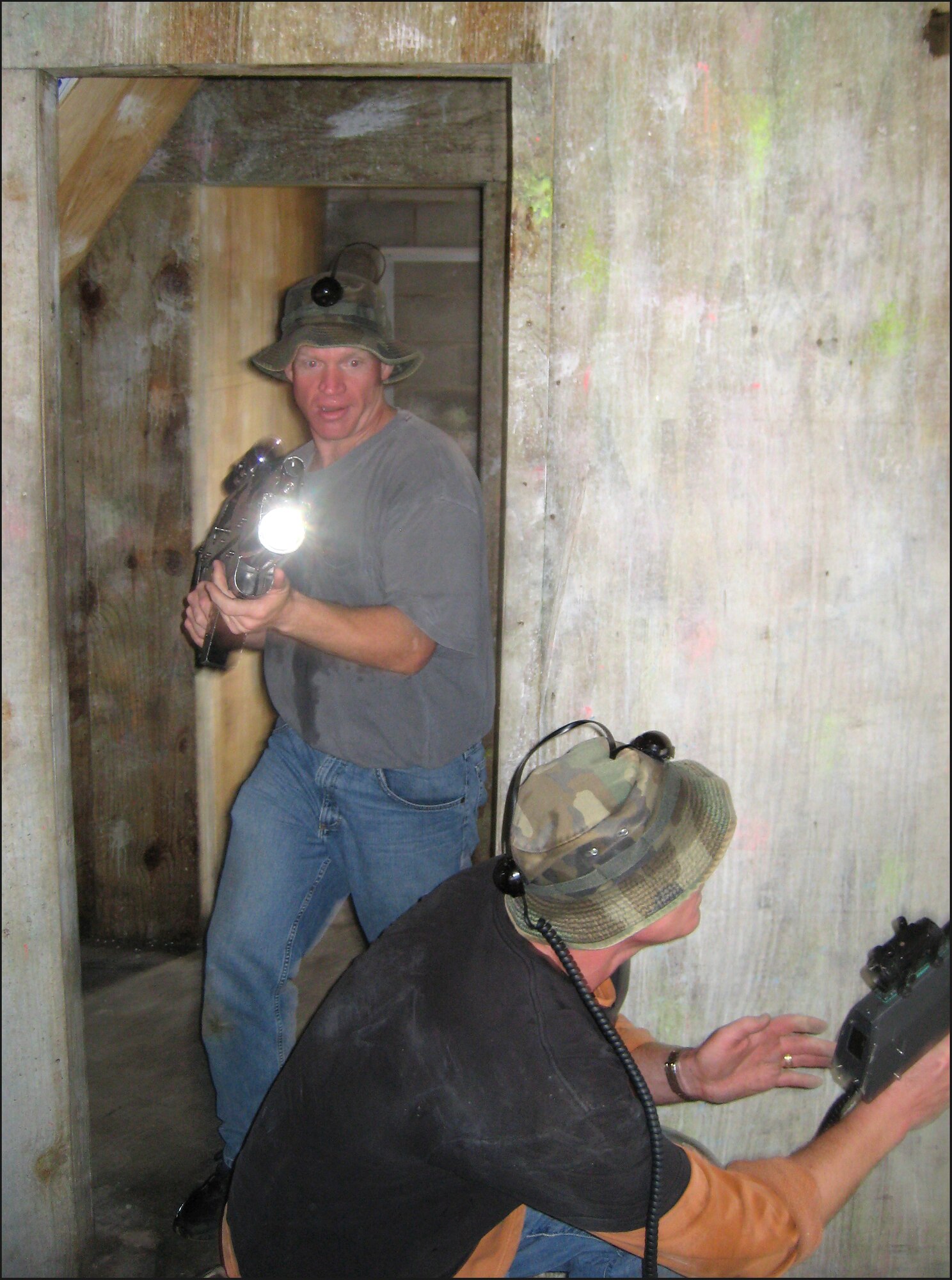 The 32nd Flying Training Squadron commander, Lt. Col. Darrell Judy, standing, and the 32nd FTS director of operations, Lt. Col. Brian Hellinger, work together to clear a room during a game of laser tag between the first assignment instructor pilots and the major weapon system instructors while deployed to Alpena, Mich. (Photo/ Capt. Anthony Cannone)