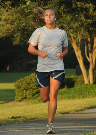 Lauren Wilson crosses the finish line at the Commander's 5K Run/Walk Challenge here Sept 11. She was the first female to complete the challenge. Wilson is a contract specialist with the 437th Contracting Squadron. (U.S. Air Force photo/Senior Airman Katie Gieratz)