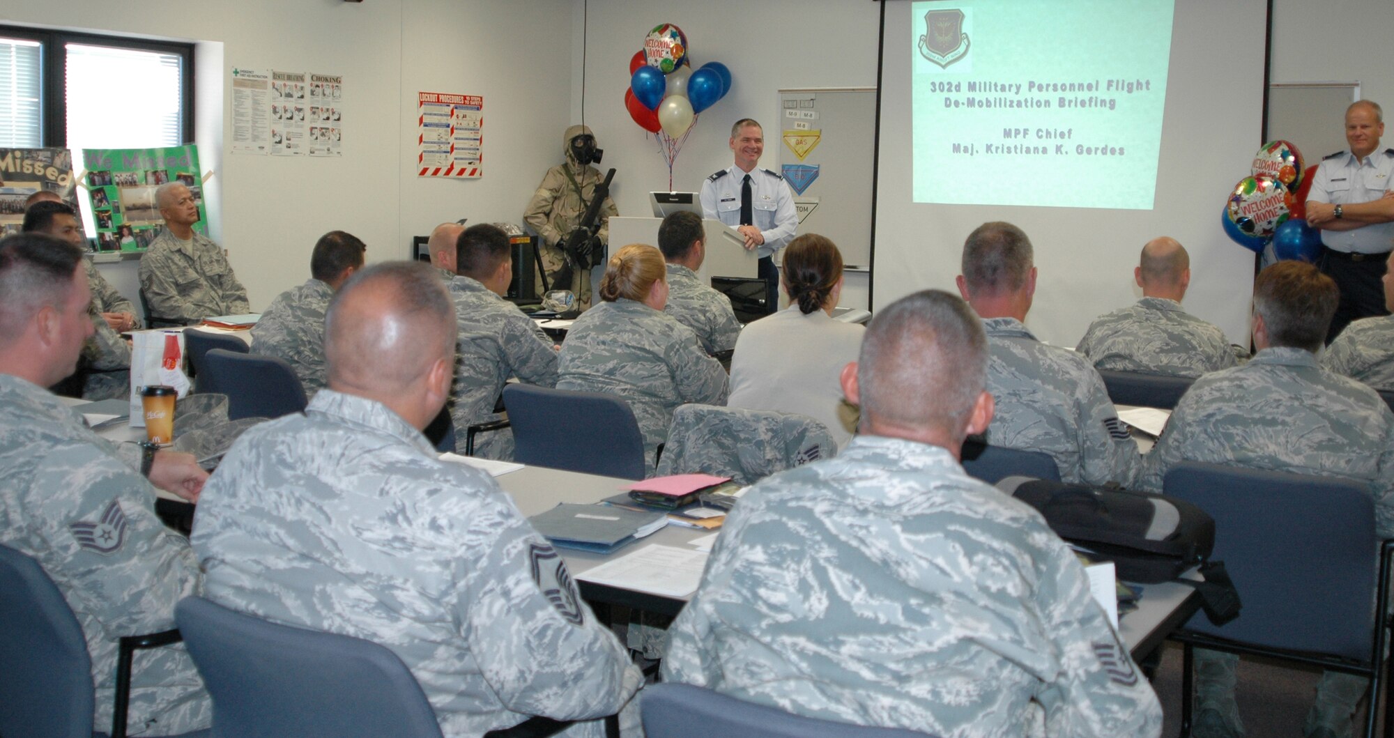 Col. Jay Pittman (left front), 302nd Airlift Wing commander, and Col. Bob Chapman (right front) welcome back members of the recently-redeployed 302nd Civil Engineer Squadron Sept. 14 during the unit's de-mobilization briefings at Peterson Air Force Base, Colo. The 35-member team returned Sept. 13 to Colorado Springs after a seven-month deployment to Kirkuk Regional Air Base in northern Iraq. While deployed, the Air Force Reservists assisted with improving base security, building repair projects, heating ventilation and cooling projects and water line repairs in addition to maintaining day-to-day operations. Colonel Chapman is the 302nd AW's vice commander. (U.S. Air Force photo/Ann Skarban)