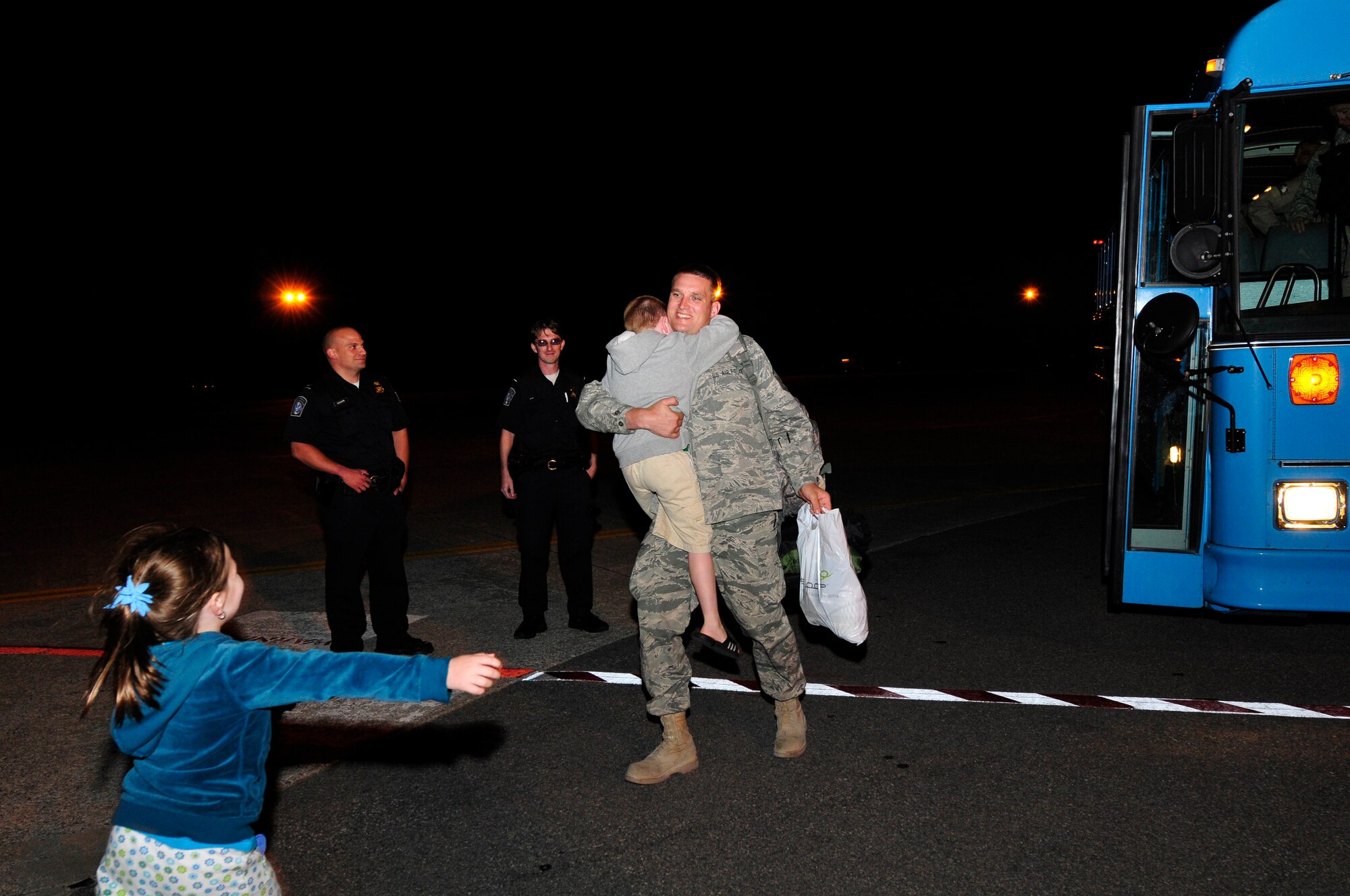 Master Sgt. Ed Holub is welcomed home from a tour in Afghanistan by his children Sept. 15 at Stratton Air National Guard Base.