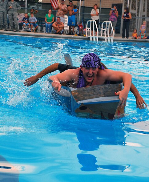 LAUGHLIN AIR FORCE BASE, Texas -- Staff Sgt. Anthony Gray, 47th Flying Training Wing chapel assistant, and Chaplain (Capt.) Kelvin Francis, 47th FTW Chaplain, race to the finish line during the third-annual Build-a-Boat Race at Friendship Pool here September 8.  (U.S. Air Force photo by Senior Airman Sara Csurilla)