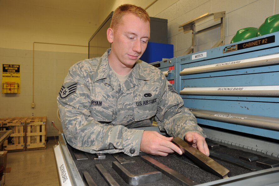 Staff Sgt. Jeremy Ryan, 22nd Maintenance Squadron Fabrication Flight, takes a bucking bar from a tool box, Sept. 14, 2009, at McConnell Air Force Base, Kan. Maintainers use bucking bars to install rivets, which are permanent mechanical fasteners similar to nails and bolts. (U.S. Air Force photo/Tech. Sgt. Chyrece Campbell)