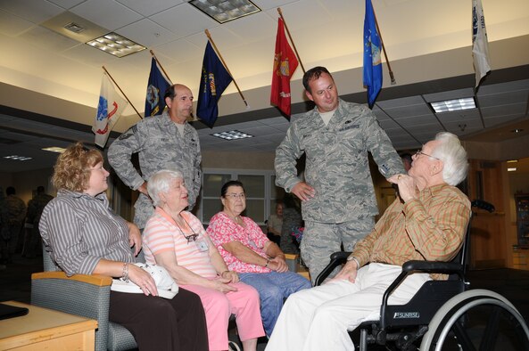 Mr. Paul Smith, WWII & Korean War veteran, shares stories with Senior Master Sgt. Bryan Lee, Tech. Sgt. Scott Russell, and family members at the Baldomero Lopez State Veteran's Nursing Home (U.S. Air Force Photo/Capt. Shane Huff)