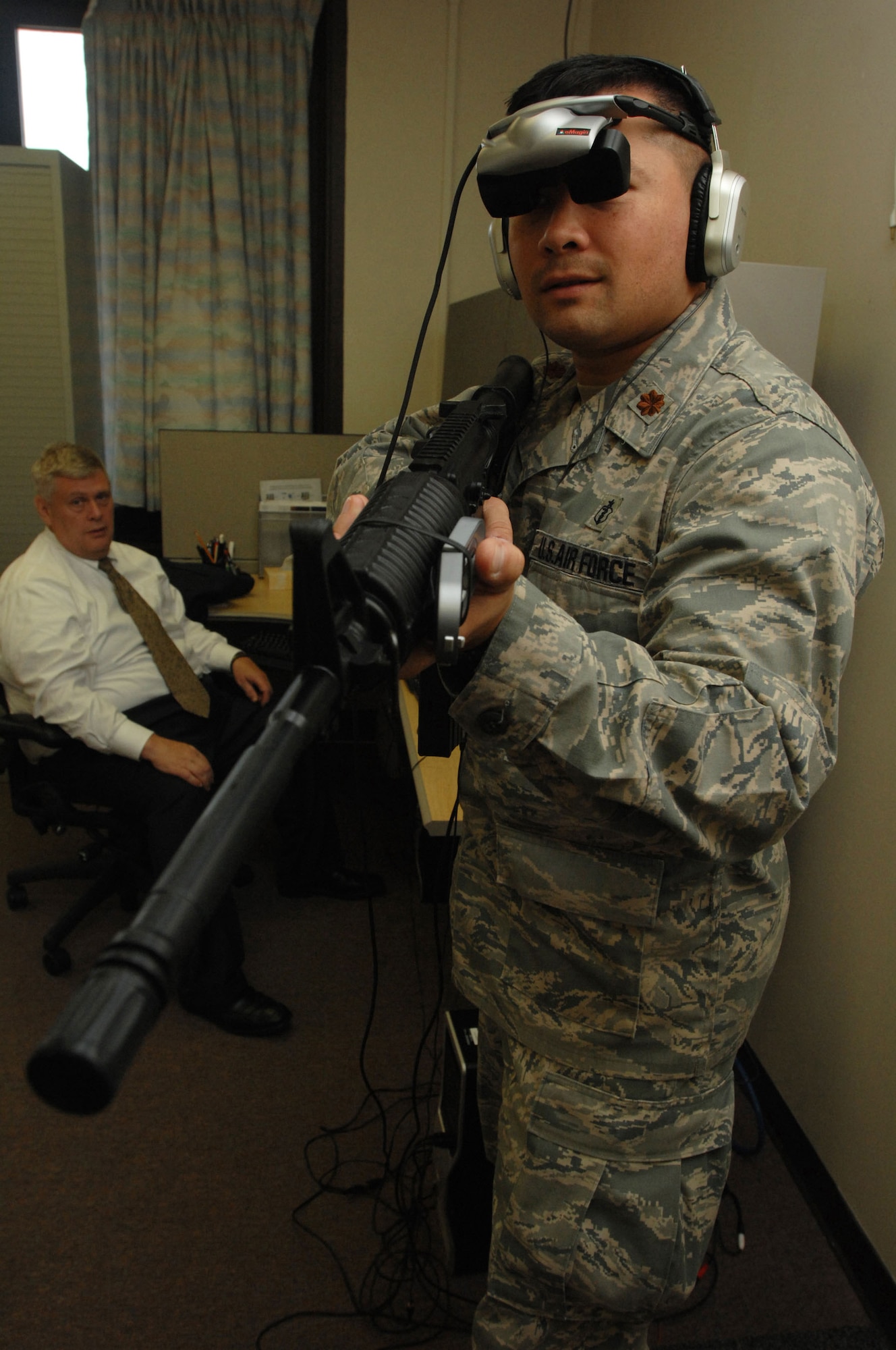 Dr. Alan Maiers (left), assistant chief, Warrior Resiliency Program, simulates a virtual reality city patrol for Maj. (Dr.) Monty Baker, director of research, Warrior Resiliency Program, Aug. 26 at Wilford Hall Medical Center, Lackland Air Force Base, Texas. The virtual reality program is designed to treat servicemembers who suffer from post traumatic stress disorder after returning from combat operations. (U.S. Air Force photo by Senior Airman Amber Bressler)