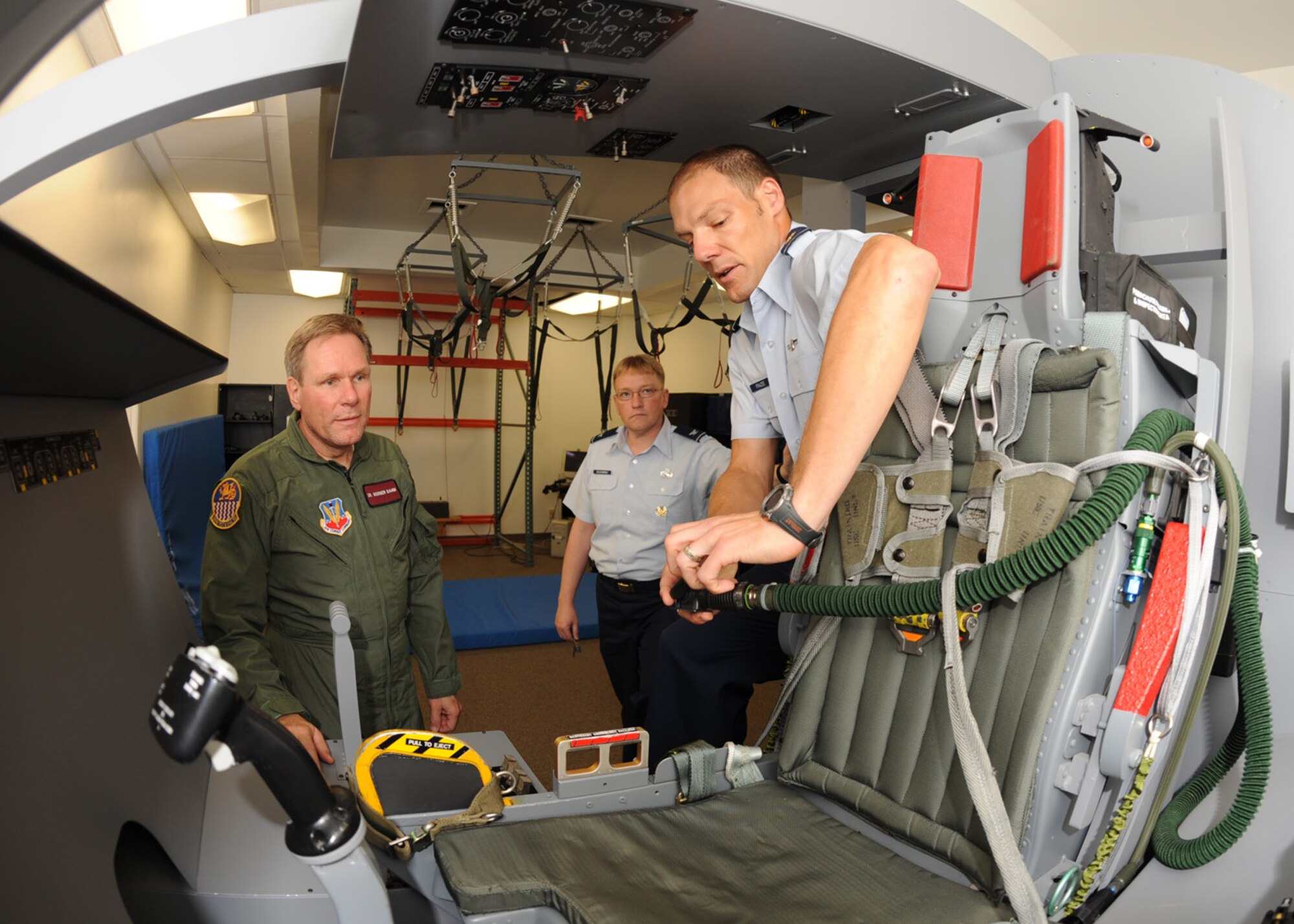 DYESS AIR FORCE BASE, Texas – Maj. Jason Frazee (right), 7th Operations Support Squadron, explains to Dr. Werner Dahm, Chief Scientist of the Air Force, how his oxygen tube will connect once inside a B-1 Lancer Sept. 12 here. While visiting Dyess, Dr. Dahm received a B-1 Lancer incentive flight. (U.S Air Force photo by Senior Airman Jennifer Romig)